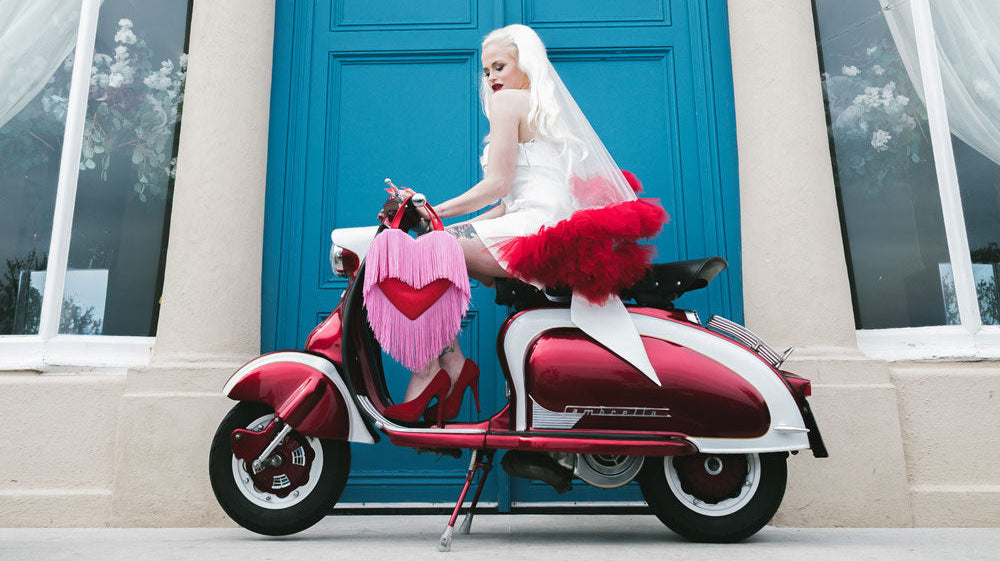 Vintage wedding hair - Bride with long blonde hair on a moped