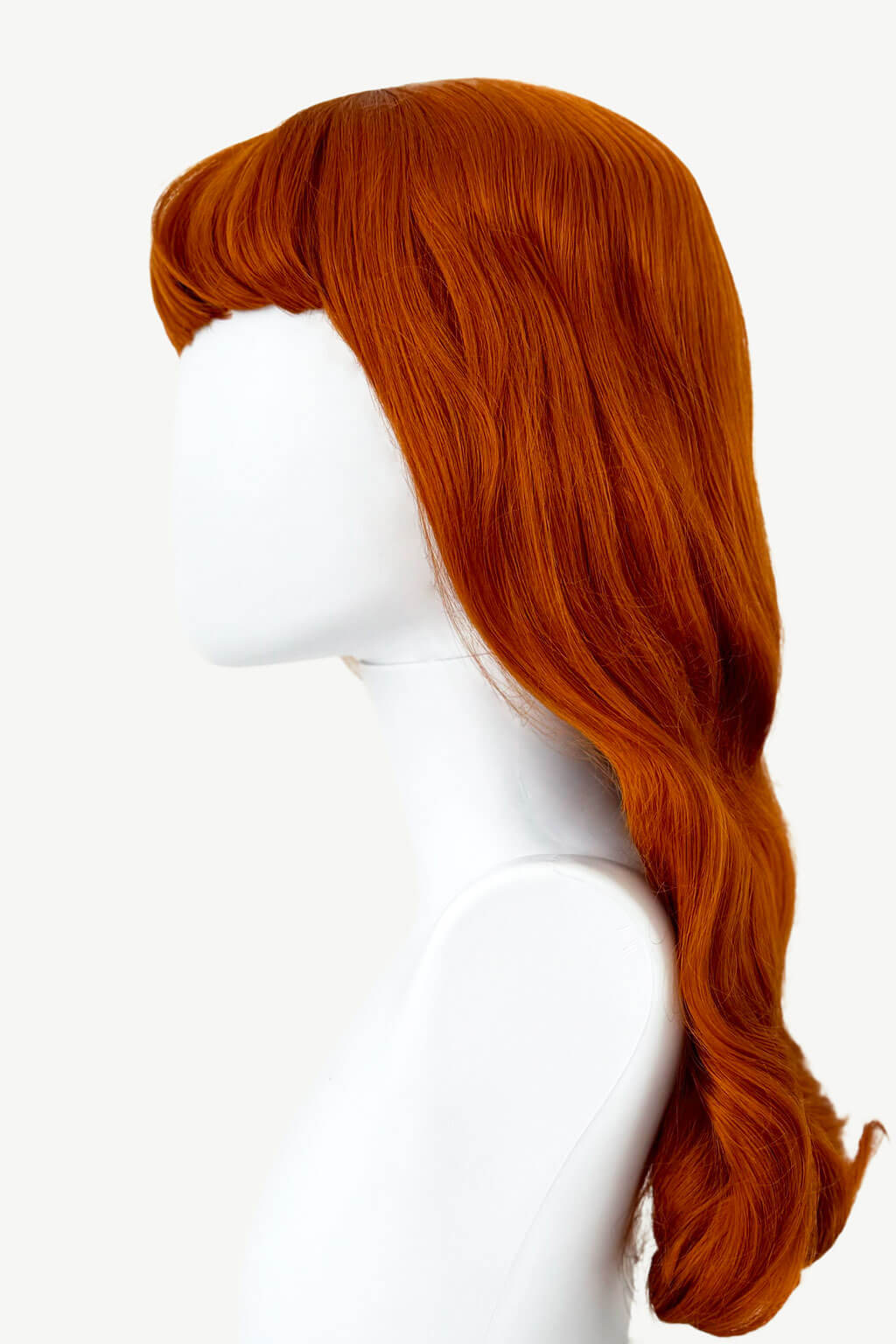 Red wig on a white mannequin head. Ginger wig, pinup style with short fringe and gentle waves, 1950s style: Vida
