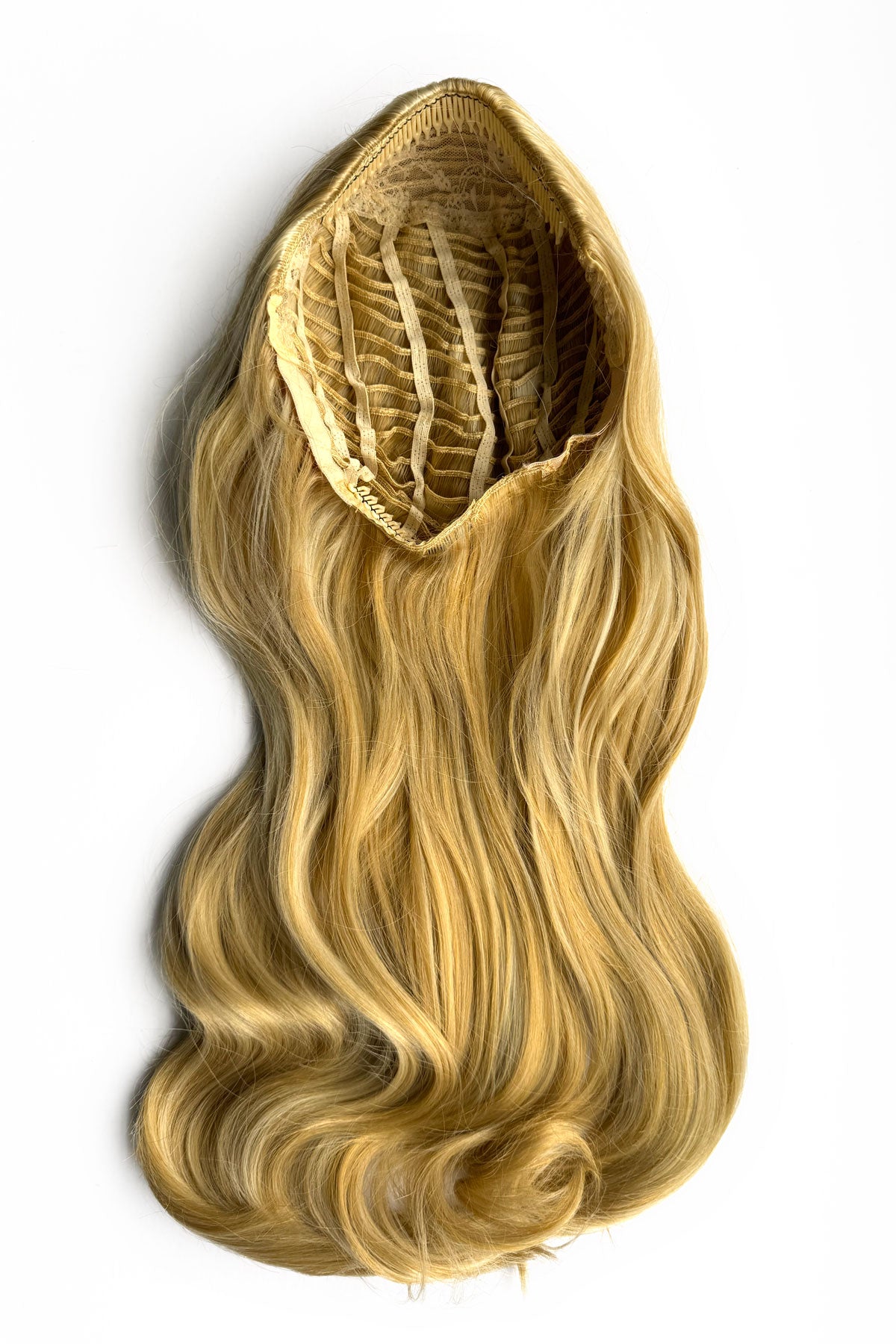 Blonde hair extension on a white background. Heat styleable half wig hairpiece, long wavy, Flexihair: Antoinette warm blonde 24BH613