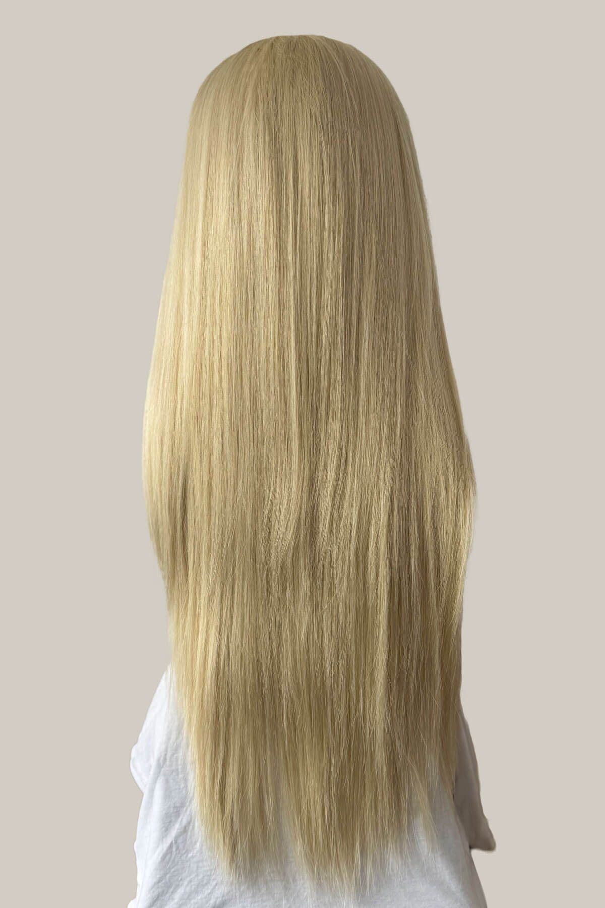 Blonde wig on a mannequin head against a plain background. Straight blonde half wig hairpiece (3/4 wig): Tabitha creamy blonde 613