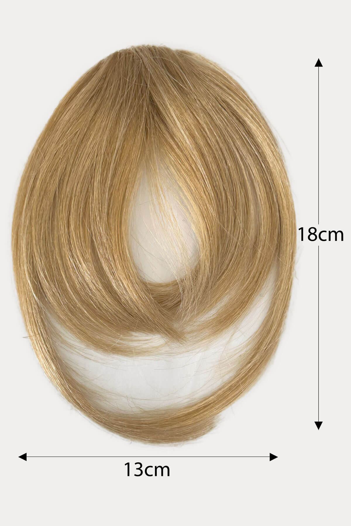 Blonde hair extension with measurements on a white background. Clip in fringe hairpiece/clip-in bangs, gently feathered with face framing whisps: Delia blonde 24H613