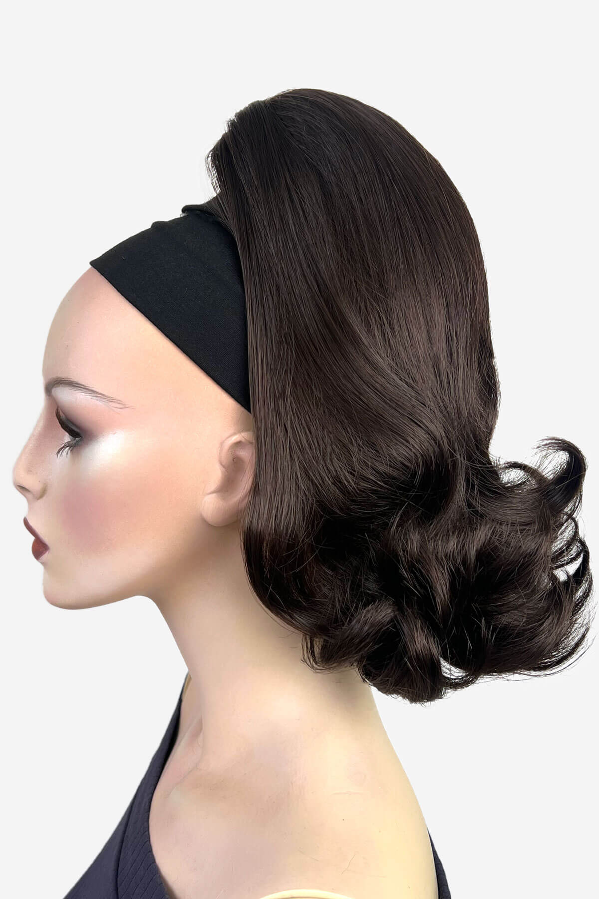Mannequin head with a dark brown hairpiece on a white background. Ponytail hairpiece, shoulder length with flick/flip, retro 1960s style: Ariana dark chocolate brown 6
