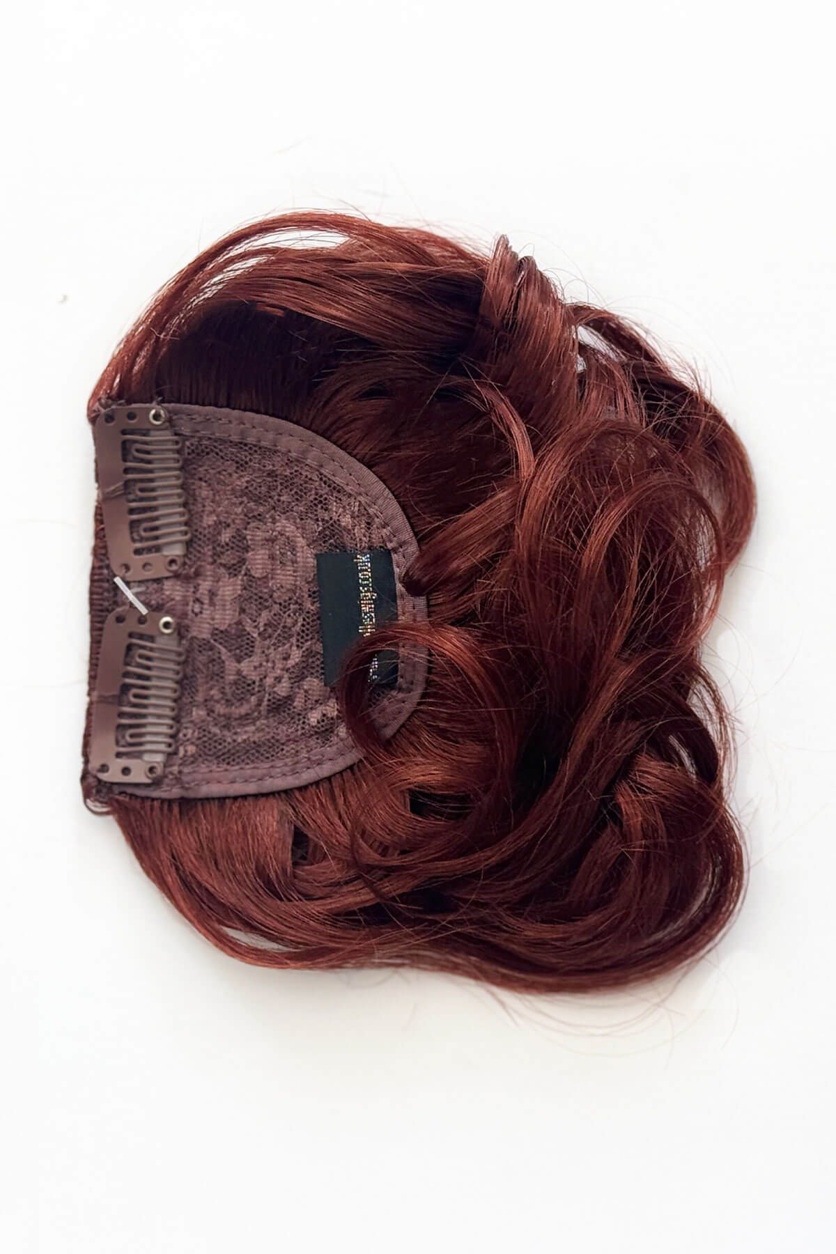 Copper red hair extension on a white background. Curly 1940s style clip-in fringe hairpiece/clip-in bangs: Bunny copper red 130
