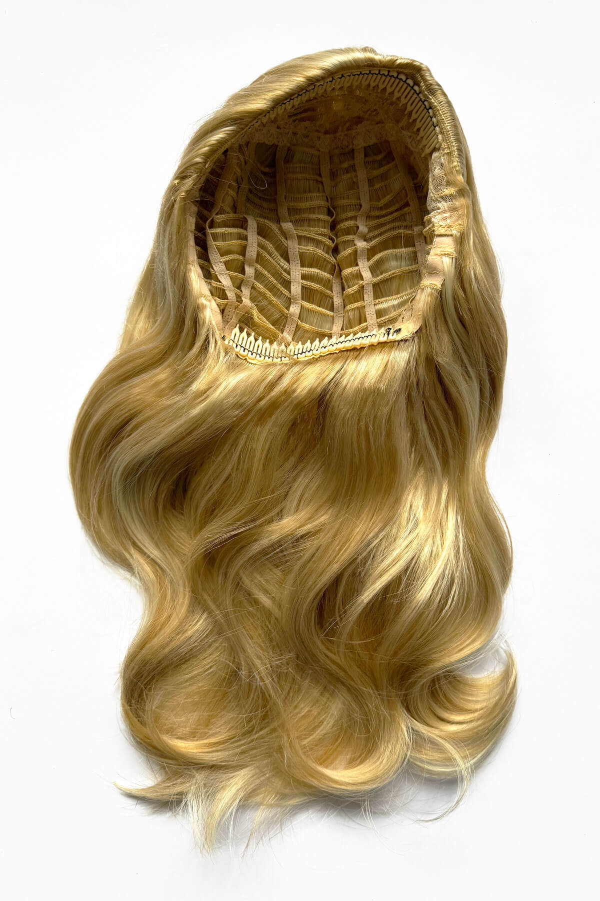 Blonde hair extension with a white background. Half wig hairpiece, long and wavy, Flexihair (Heat styleable) and volume ring for high crown: Sharon honey blonde 24BH613