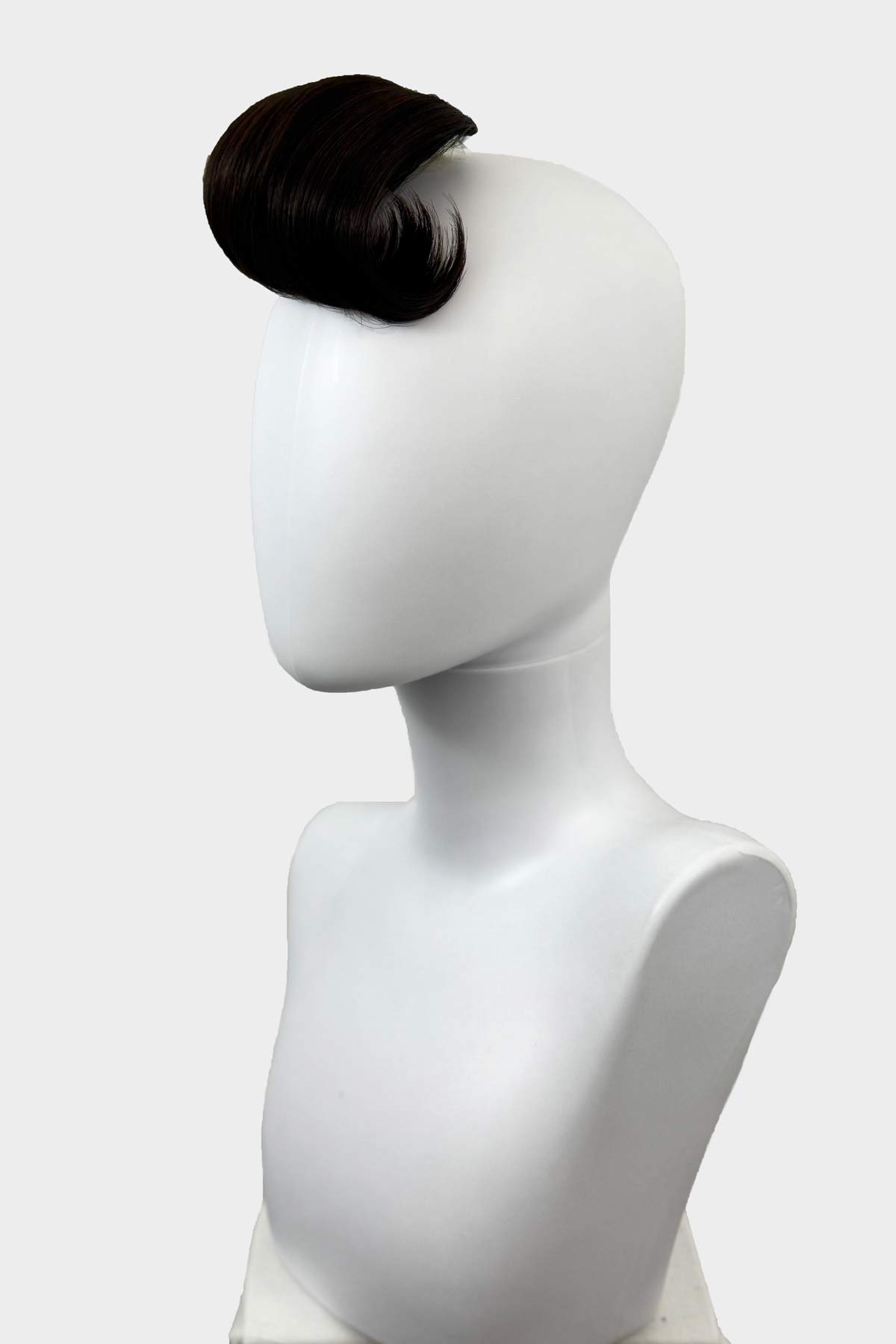 Black hairpiece on a white mannequin head against a light gray background. Black hairpiece on a white mannequin head against a white background. Victory roll fringe/bangs hairpiece, 1950s vintage style: Rosa dark brown 4