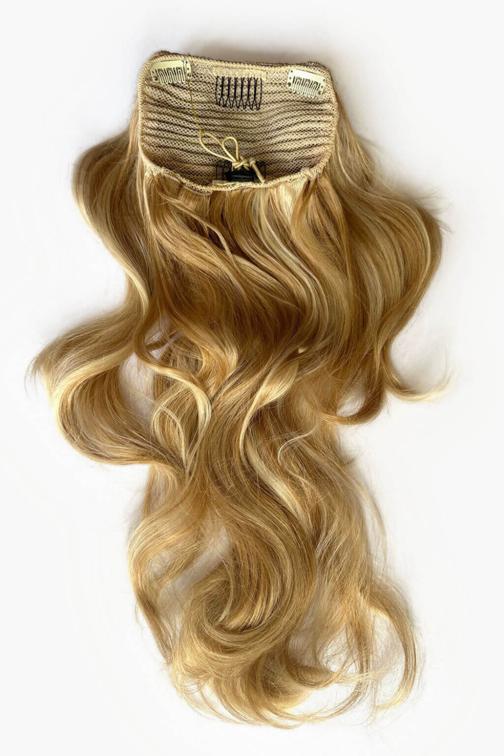Blonde hair extension with a drawstring attachment on a white background. Double volume hairpiece extension: Naomi warm blonde 24BH613