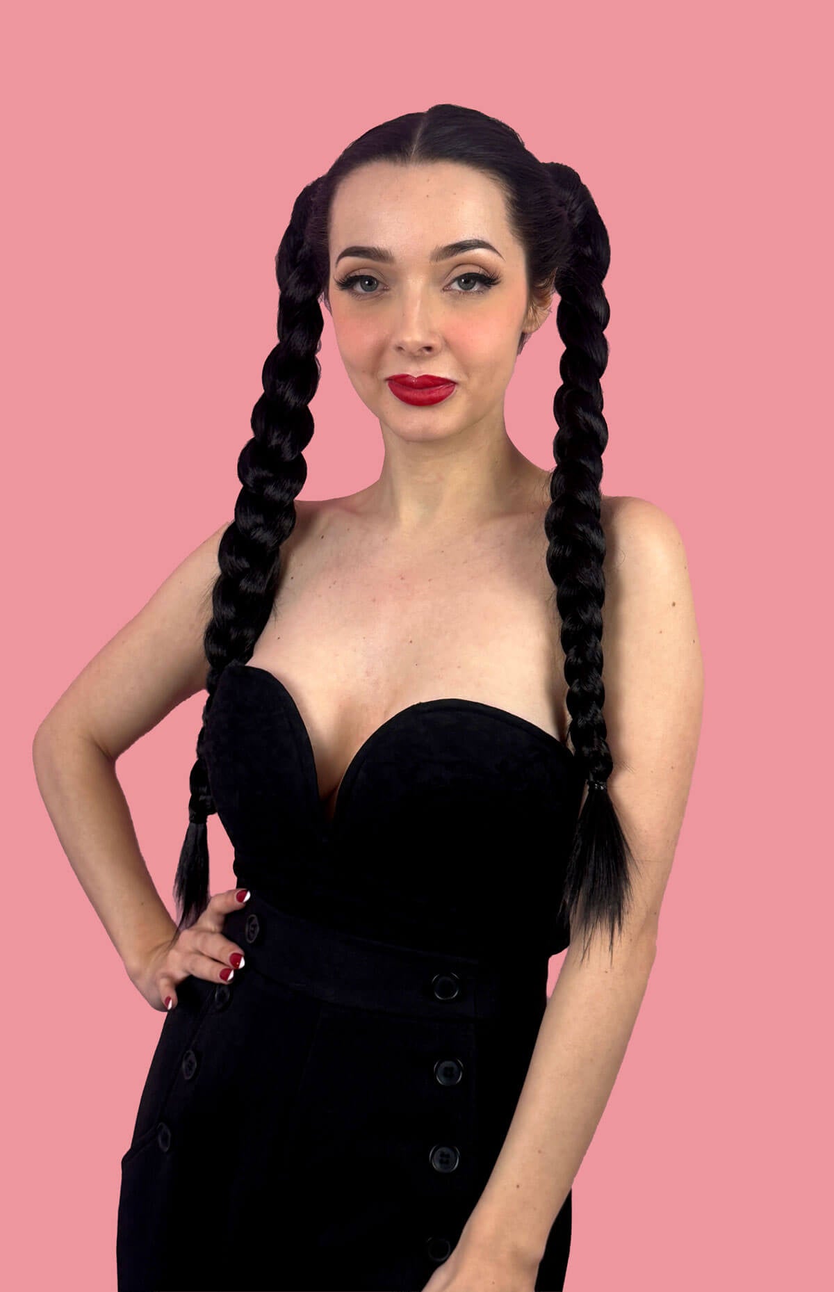 Woman with long braided hair wearing a black dress. Long double plaited ponytail hairpiece: Martha black 1B
