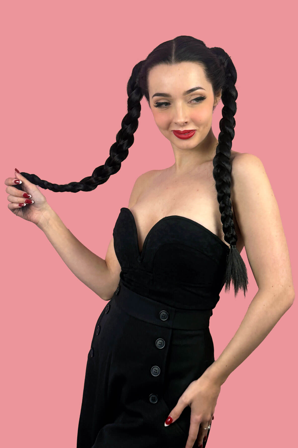 Woman with long braided hair wearing a black dress. Long double plaited ponytail hairpiece: Martha dark brown 4