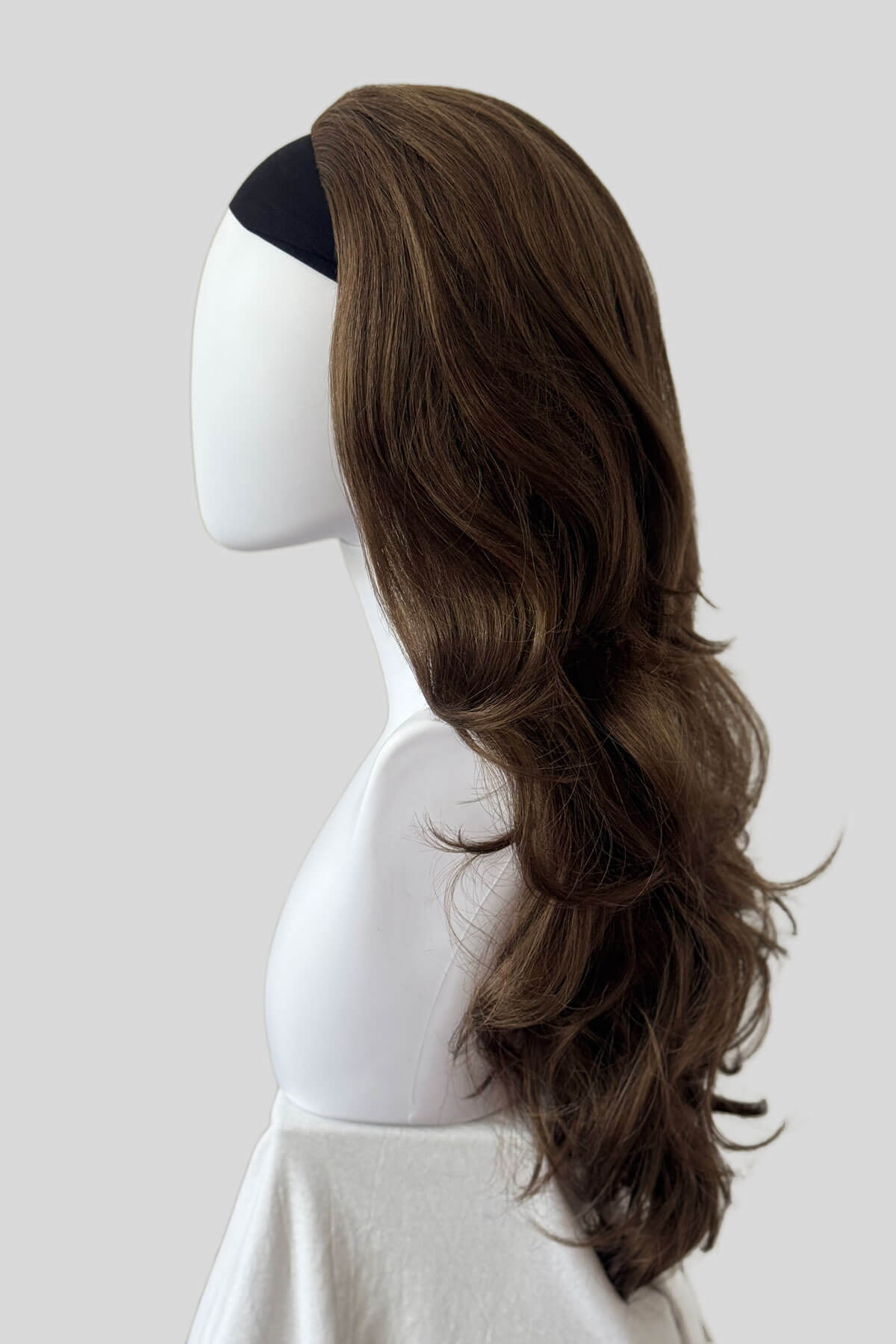 Mannequin head with long brown wig on a white background. Brown half wig hairpiece with long loose curls: Chelsea mocha brown 10