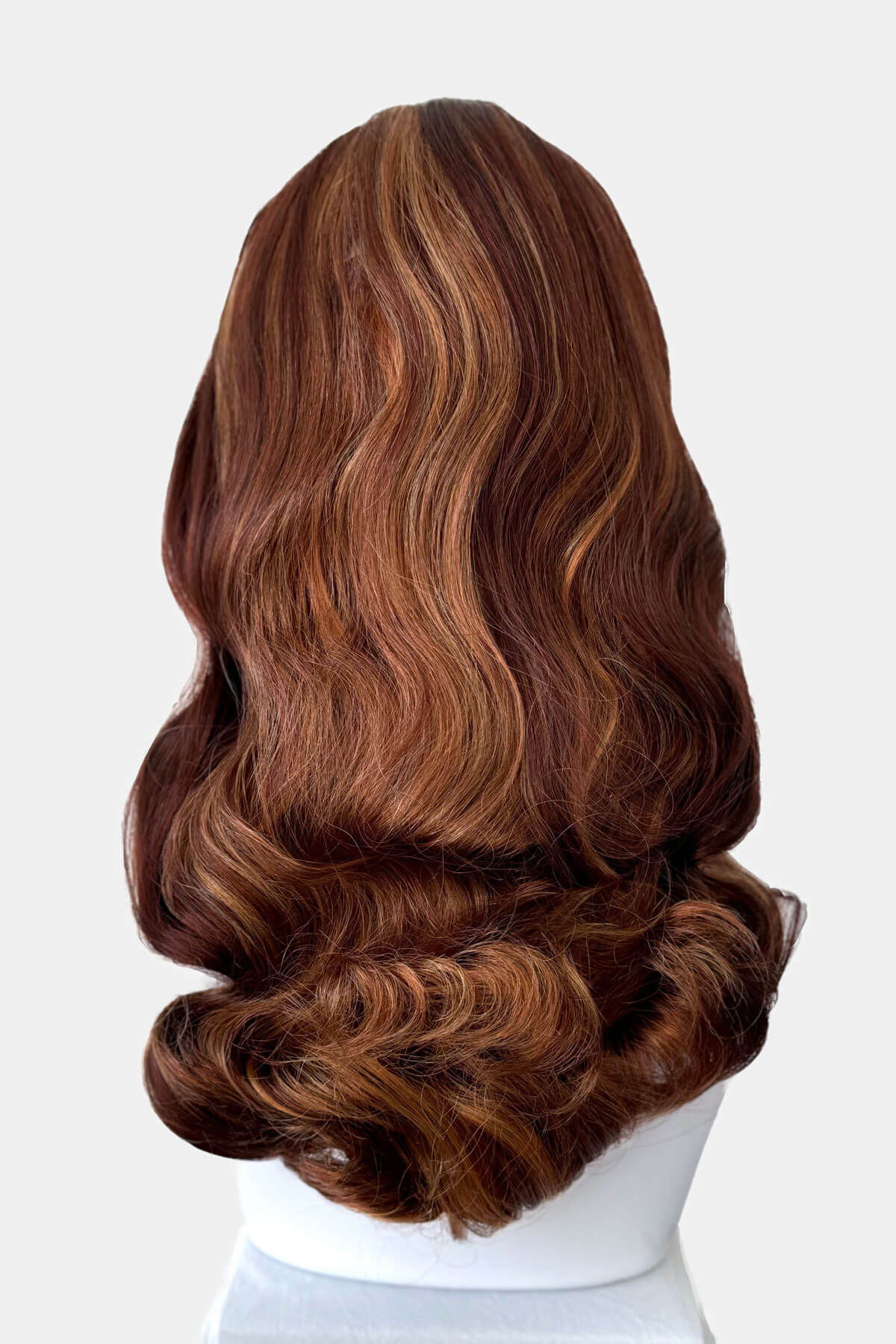 Auburn and blonde wig on a mannequin head against a white background. 1950s style half wig hairpiece with beautiful waves: Morgana auburn BO