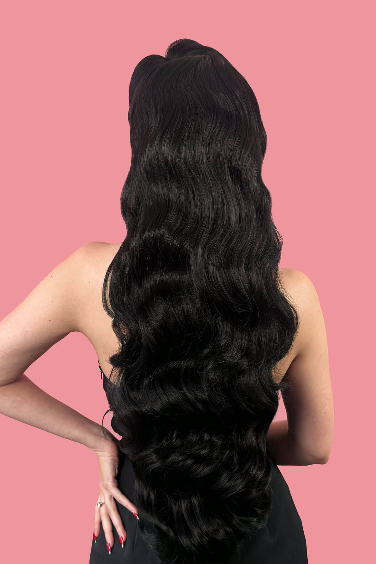 Woman with long, wavy black hair on a pink background. Ultra long half wig with hollywood waves. black 1B