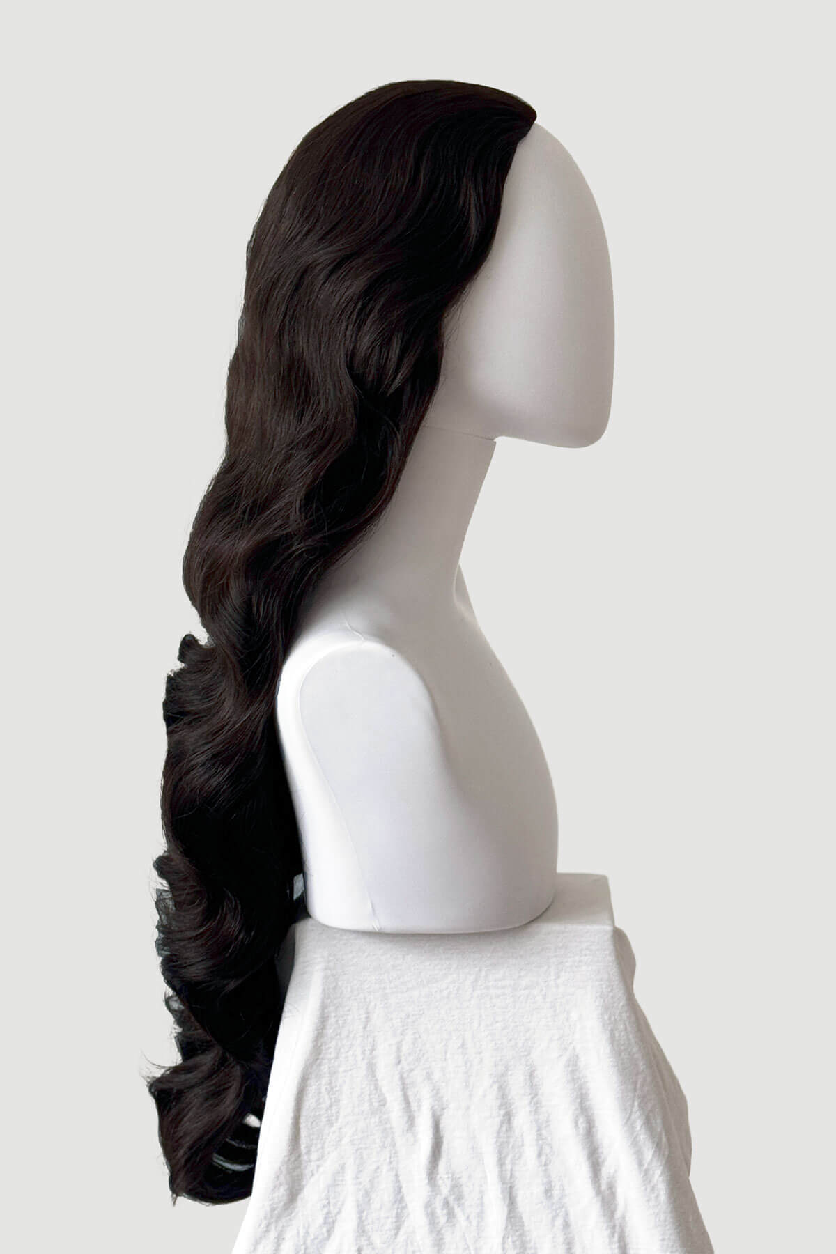 Mannequin head with long, dark brown hair styled in a ponytail on a plain background. Ultra long half wig with hollywood waves. dark brown 4