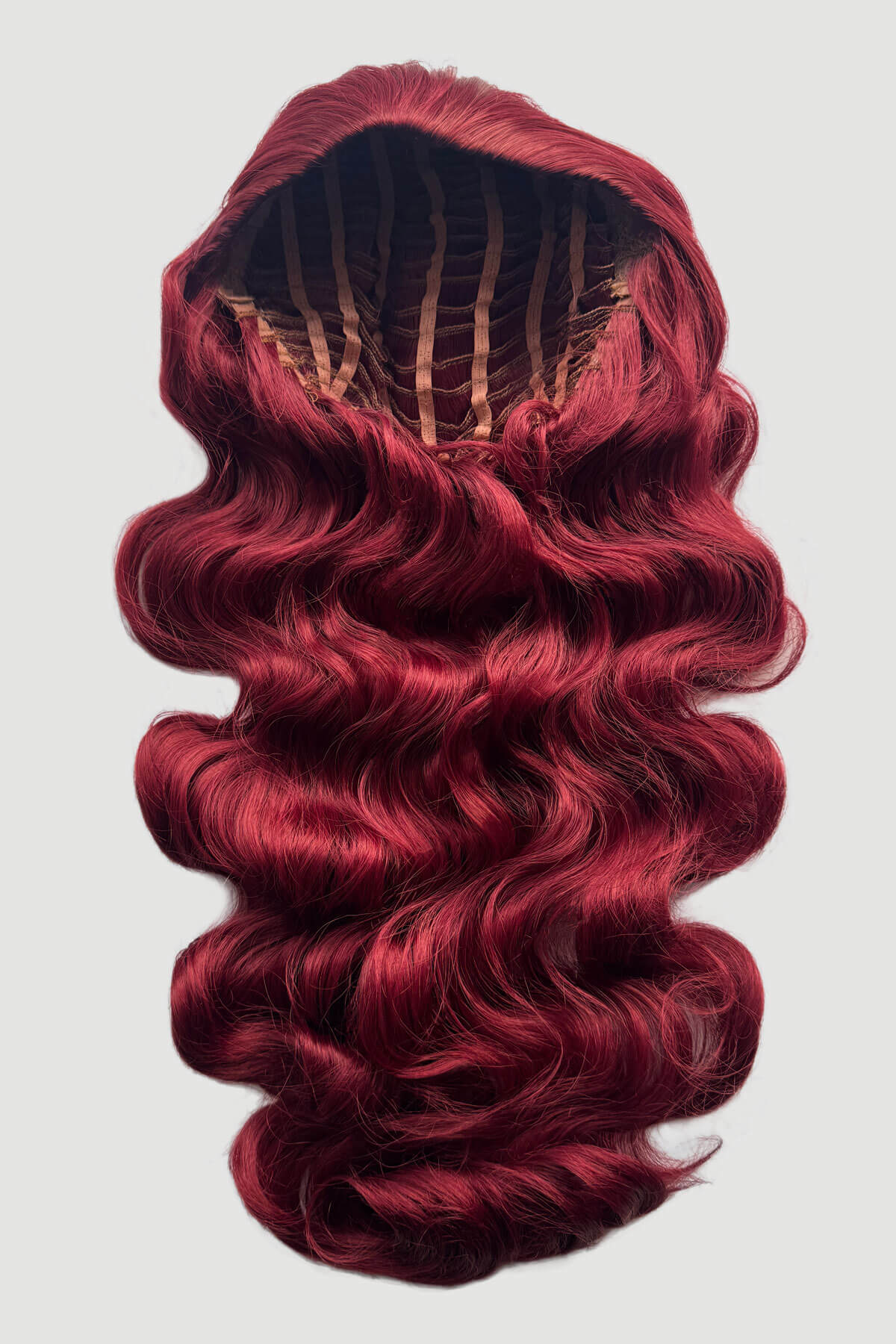 Mannequin head with long, red hair styled in a ponytail on a plain background. Ultra long half wig with hollywood waves. cherry red 39