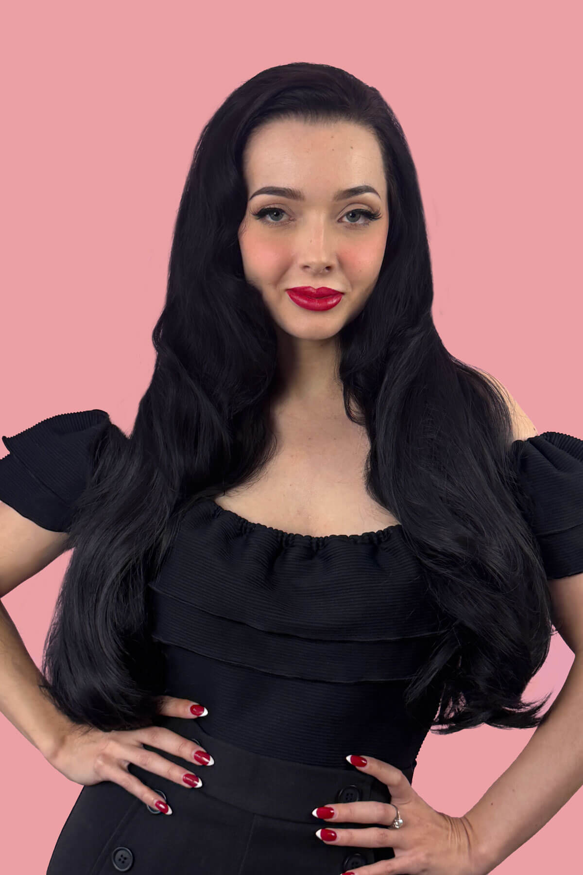 Woman with long black hair wearing a black dress against a pink background. Heat styleable half wig hairpiece (3/4 wig), long wavy, Flexihair: Kate black 1B