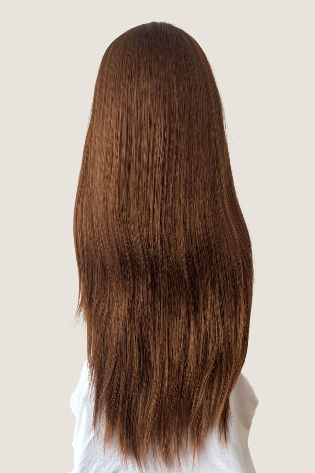 Long brown hair on a neutral background. Straight brown half wig hairpiece extension, long: Faye Auburn brown 30