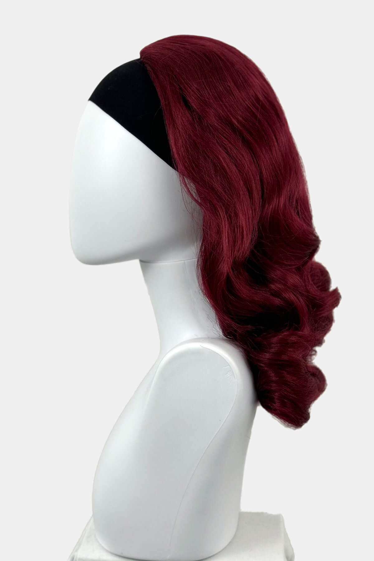 Red wig on a white mannequin head against a white background viewed from the back. 1950s style shoulder length half wig hairpiece with beautiful vintage waves: Onyx cherry red 39