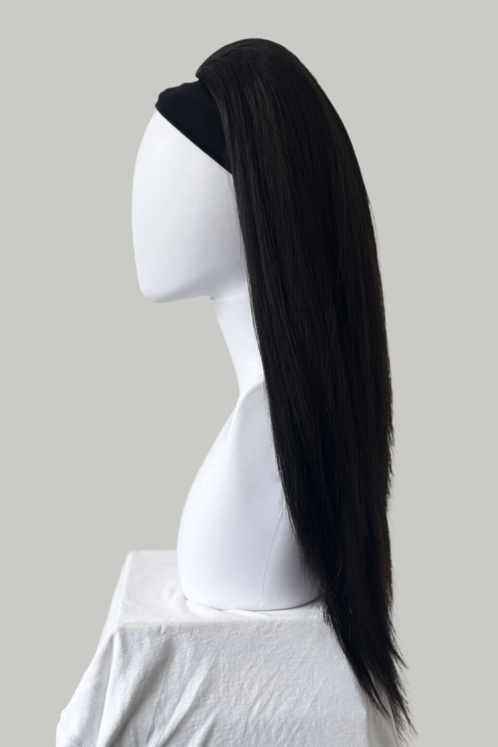 Dark brown wig on a mannequin head against a plain background. 1960s style hair, high crown long straight half wig: Andrea Dark brown 4