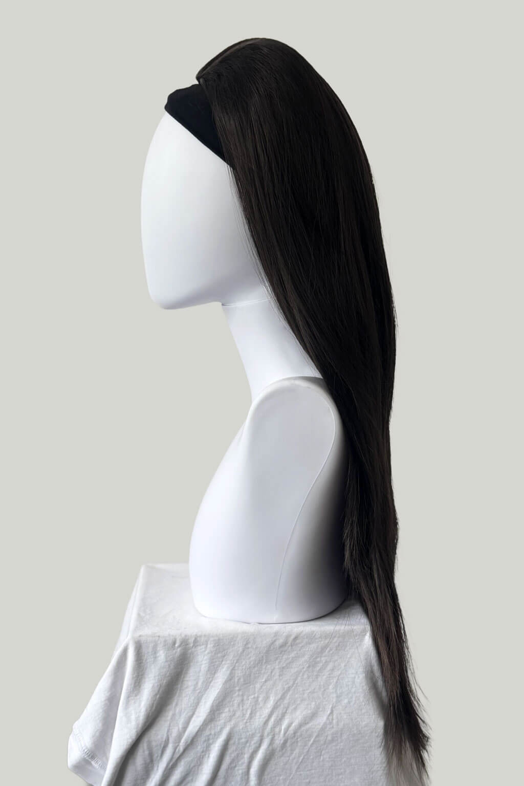 Dark chocolate brown wig on a mannequin head against a plain background. 1960s style hair, high crown long straight half wig: Andrea dark chocolate brown 6