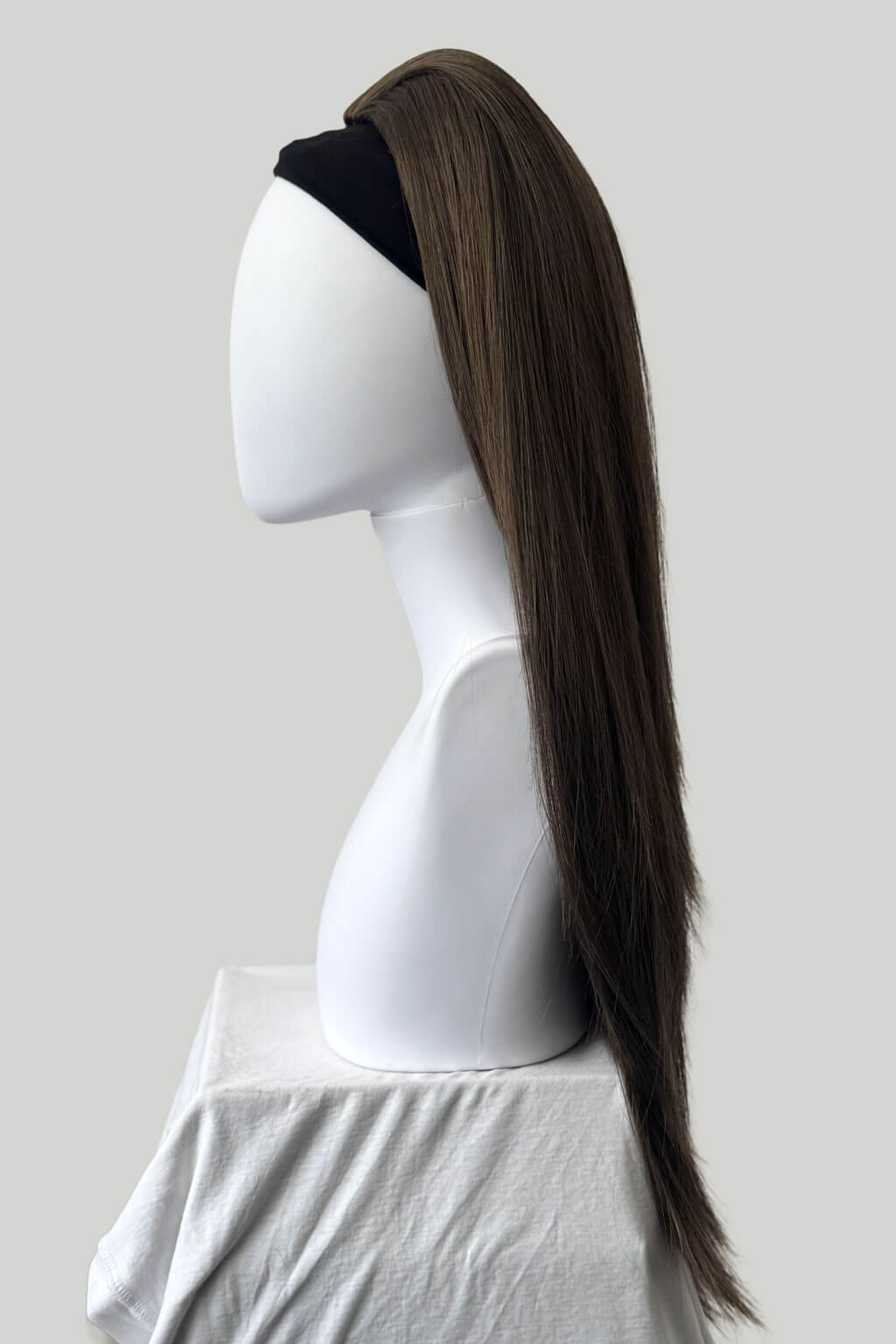 Mannequin head with a long brown hairpiece on a white background. 1960s style hair, high crown long straight half wig: Andrea mocha brown 10