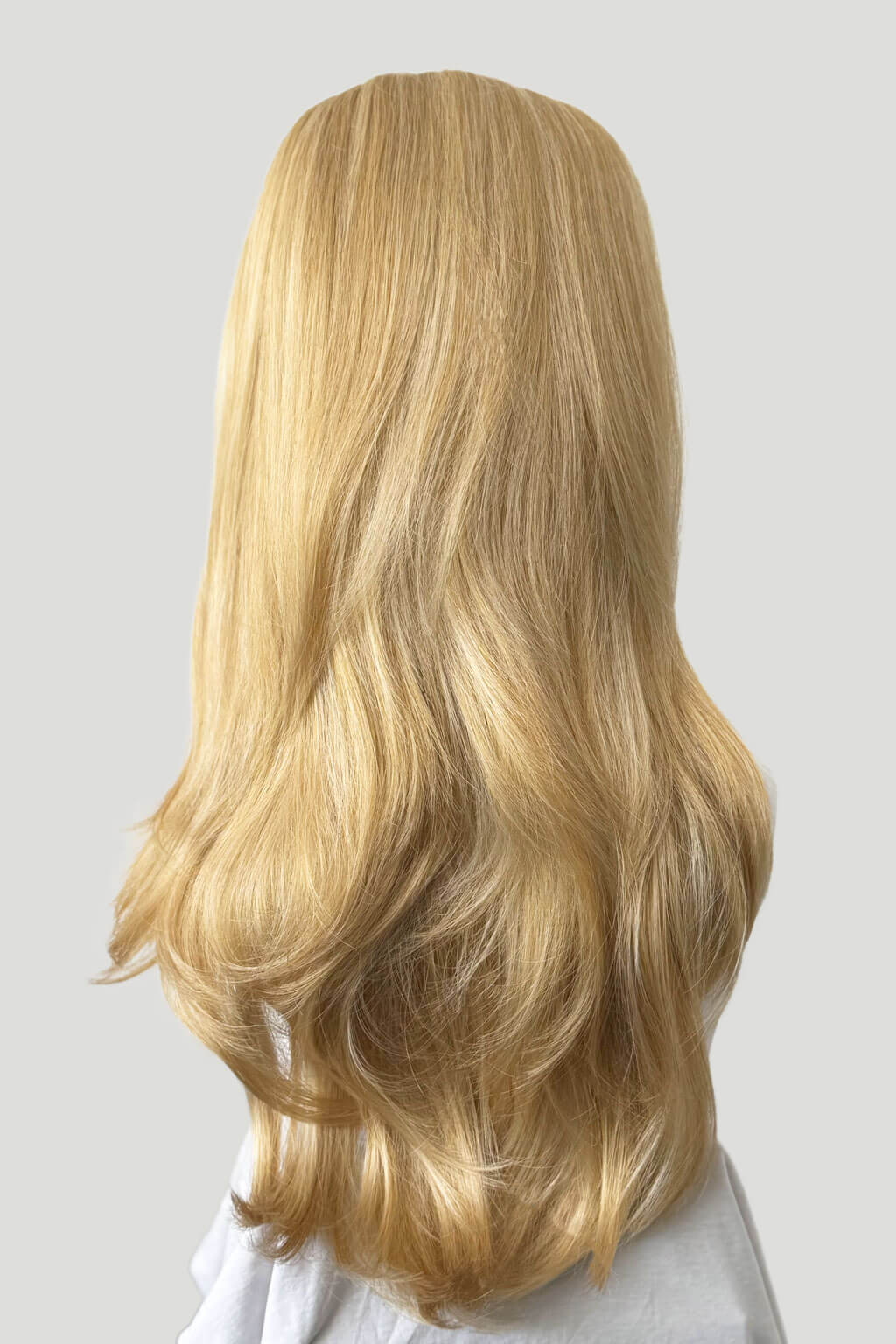 Blonde half wig on a white background. 1960s style hair, high crown long straight and layered half wig: Juliette golden blonde 24BH613