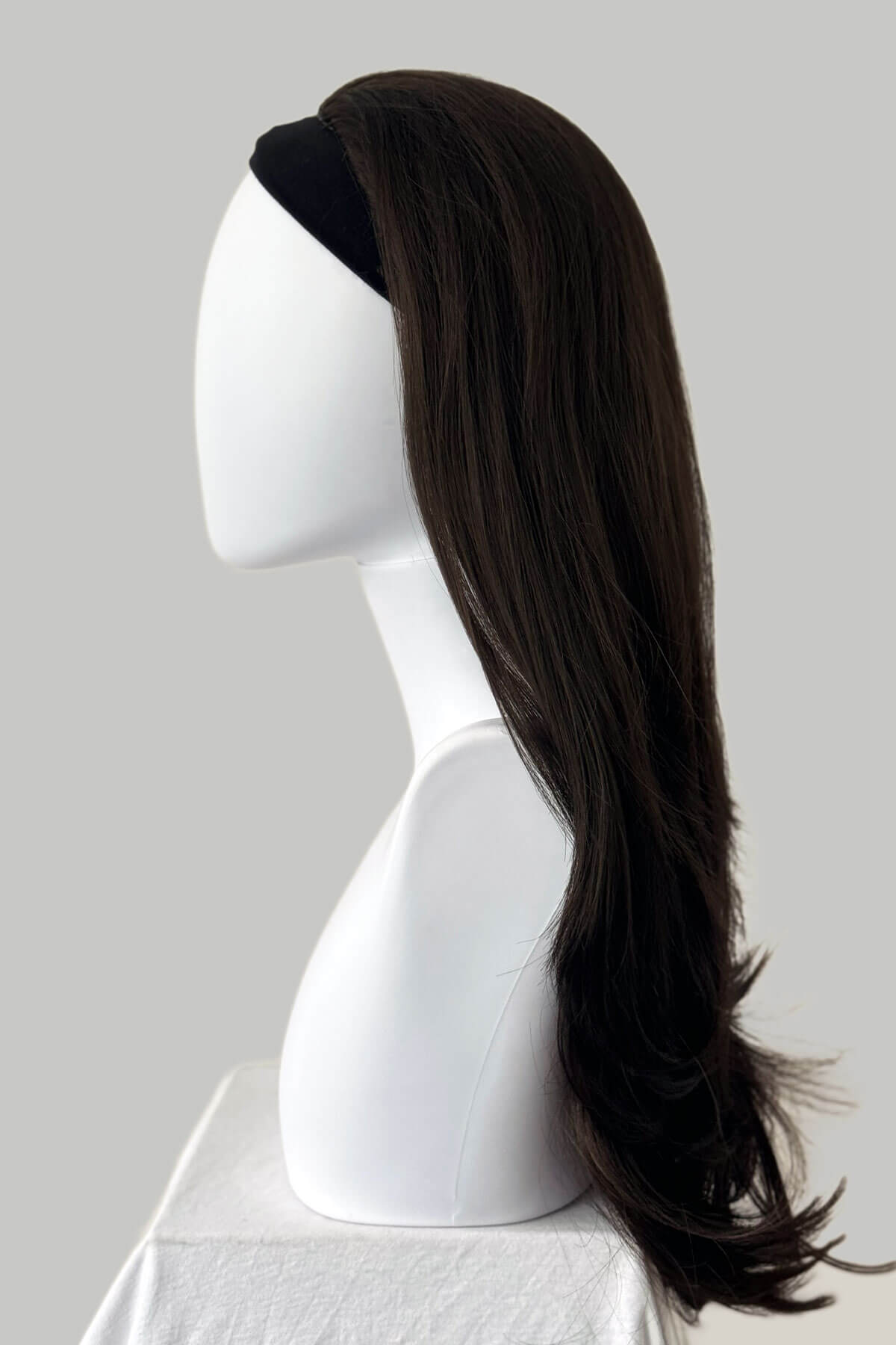Mannequin head with long brown hair on a plain background. Brown half wig hairpiece, layered and straight: Summer dark chocolate brown 6