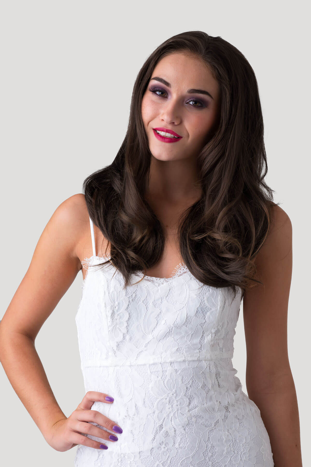 Woman wearing a white lace dress against a plain background. Brown half wig hairpiece (3/4 wig), gently layered: Briar chestnut brown 8