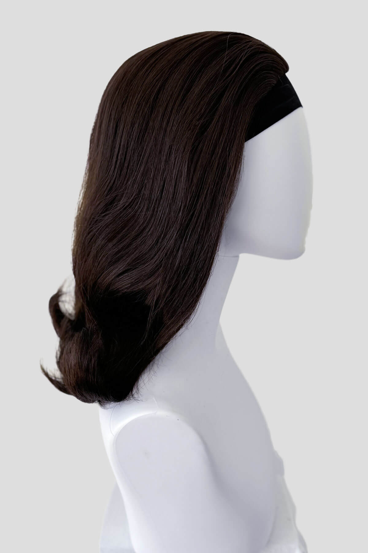 Dark brown wig on a mannequin head against a white background.  1960s half wig hairpiece, flicked, hair flip: Philippa dark chocolate brown 6