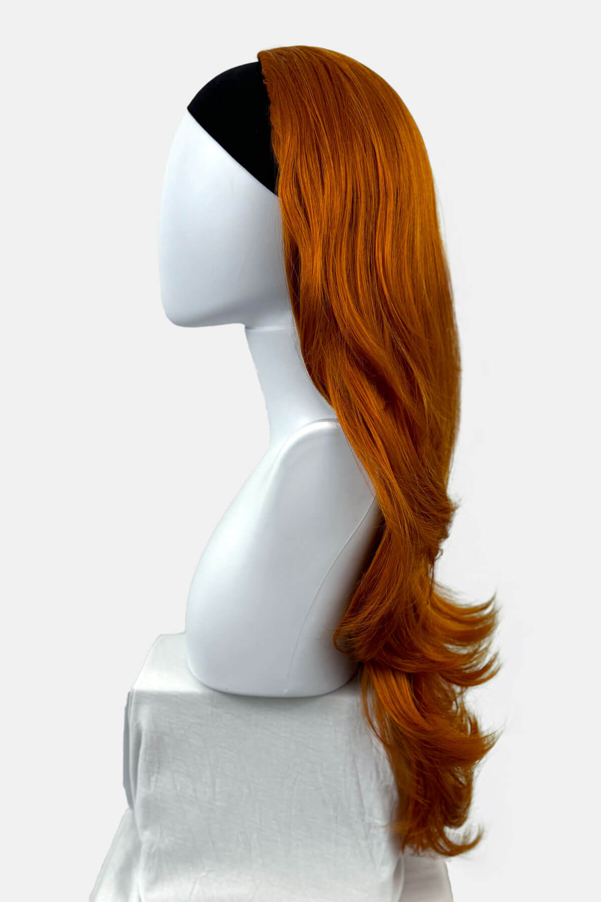 Mannequin head with orange wig on a white background. Wavy ginger half wig hairpiece extension (3/4 wig): Eris