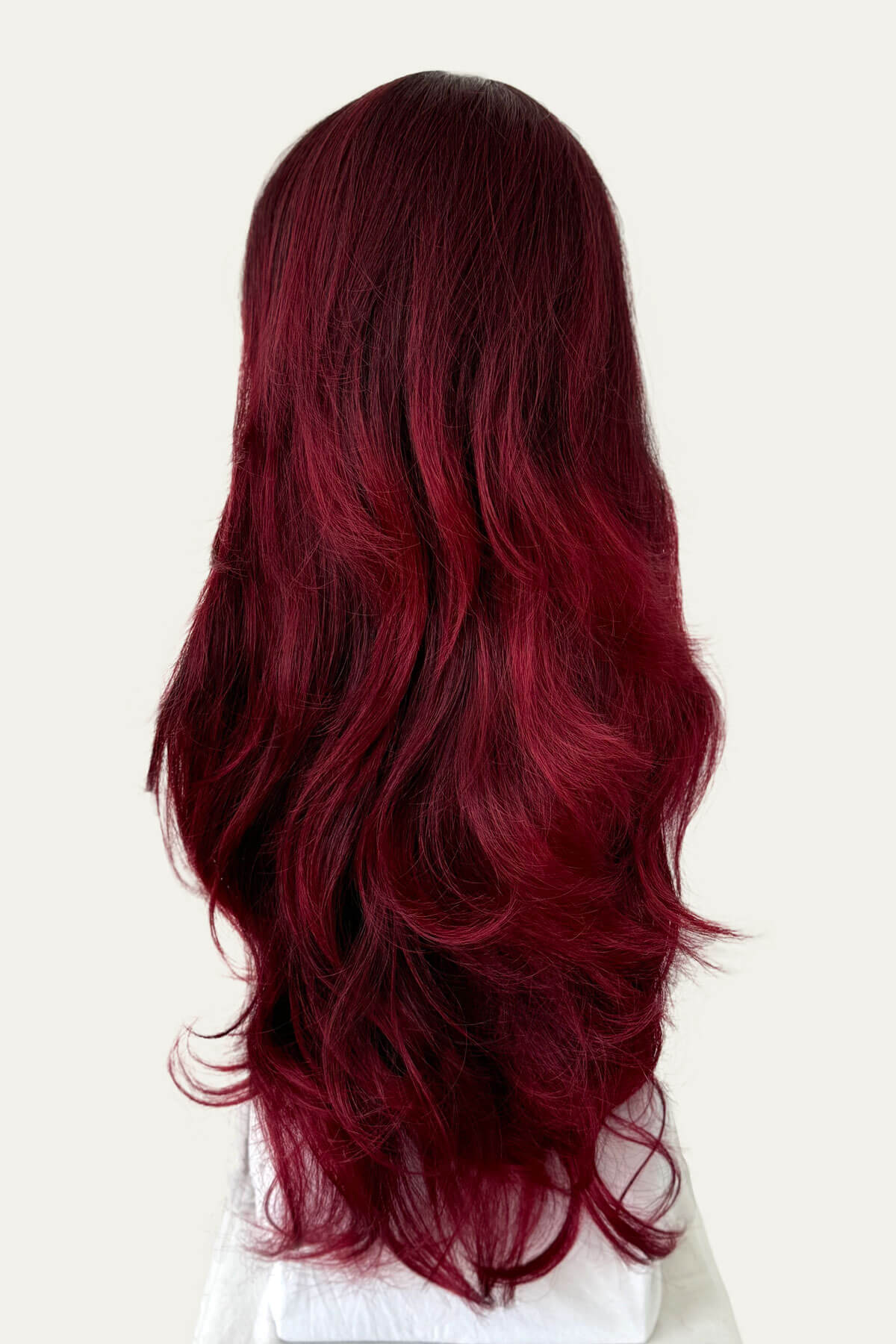 Long, wavy red hair on a white background. Black and red half wig hairpiece (3/4 wig), loose curls: Monica