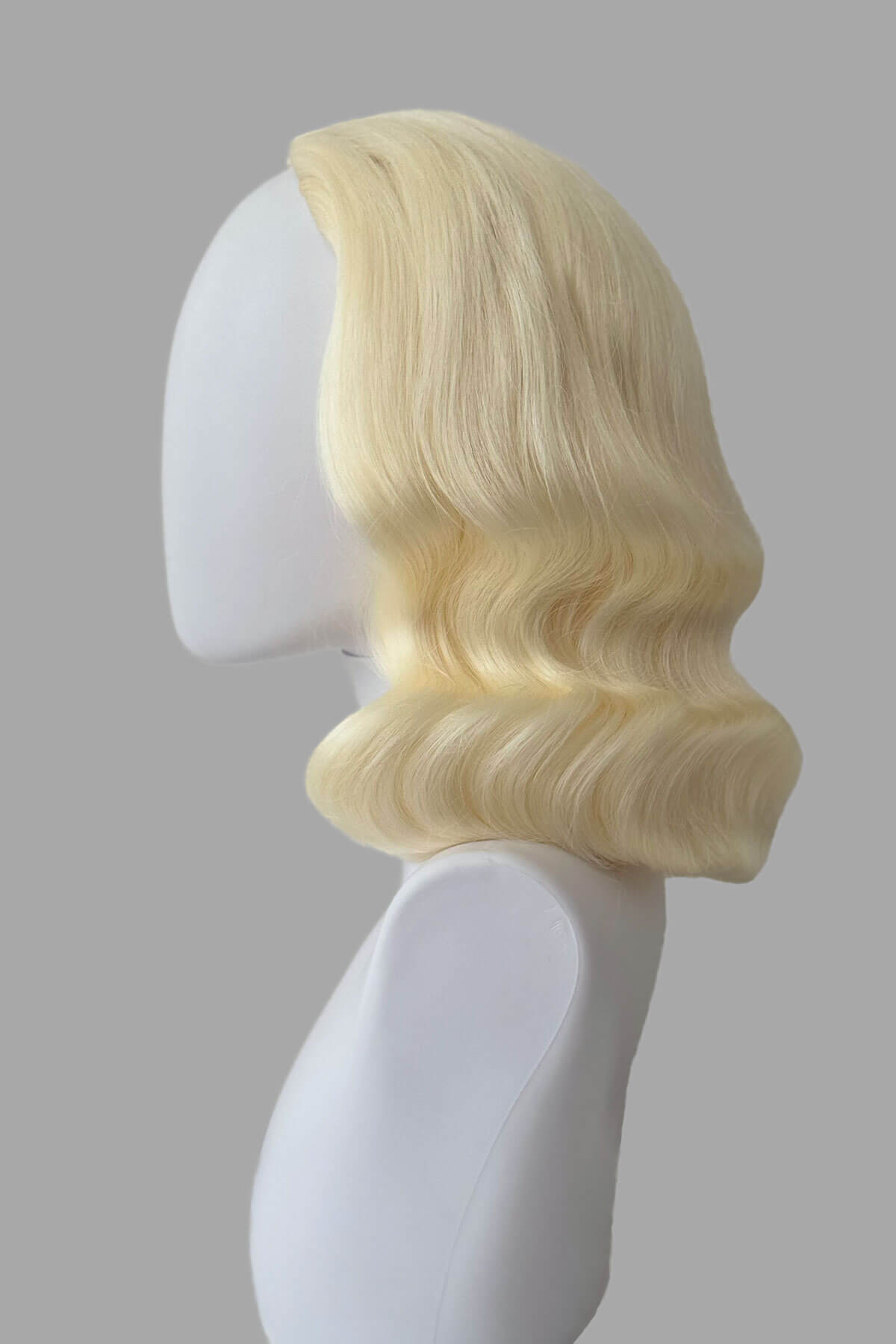 Mannequin with vintage style wig with marcel waves on it, from the side. 1940s style half wig hairpiece with beautiful marcel waves: Virginia platinum 10001