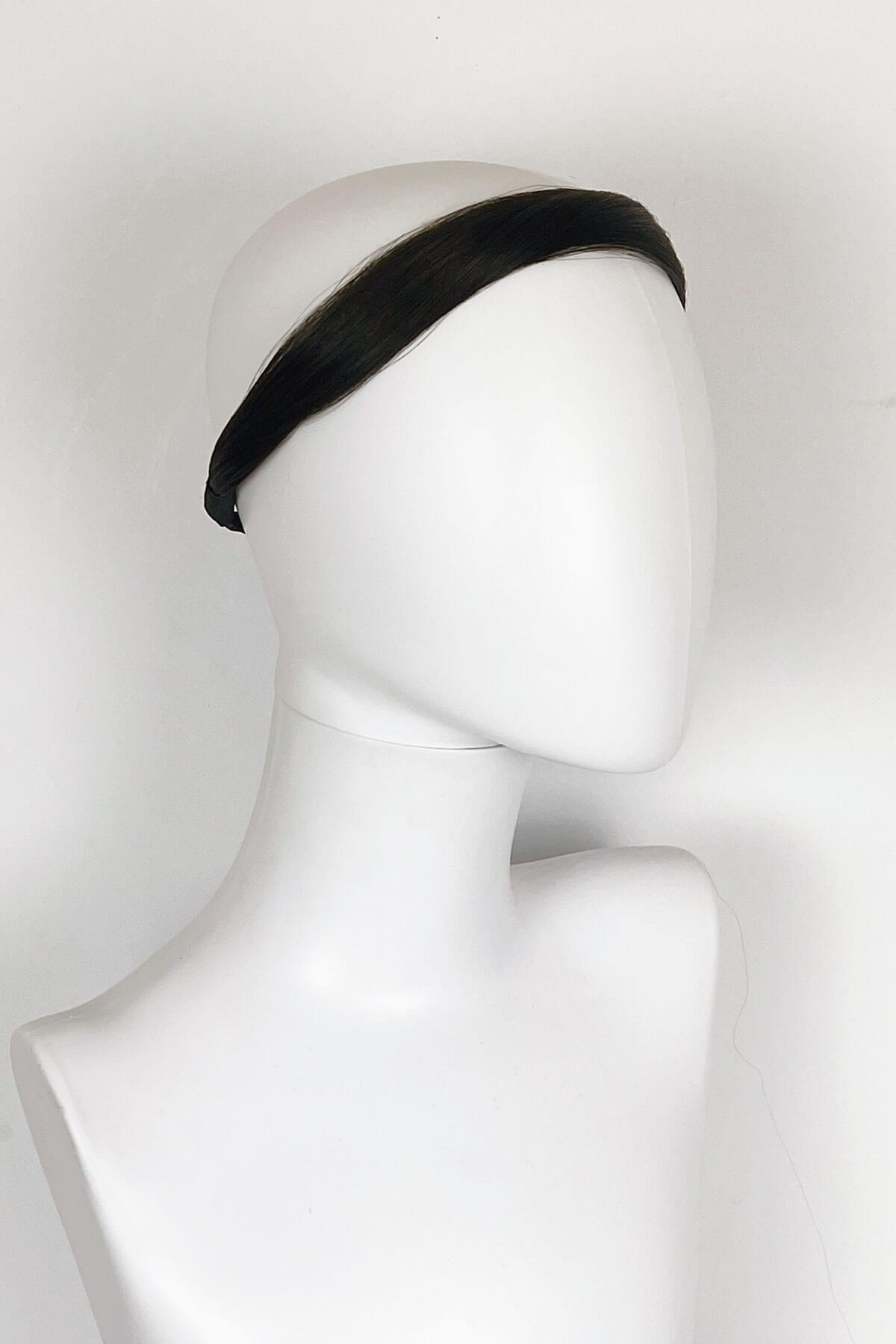 Black headband on a mannequin head against a white background. Loose hair hairband: Mabel dark brown 4