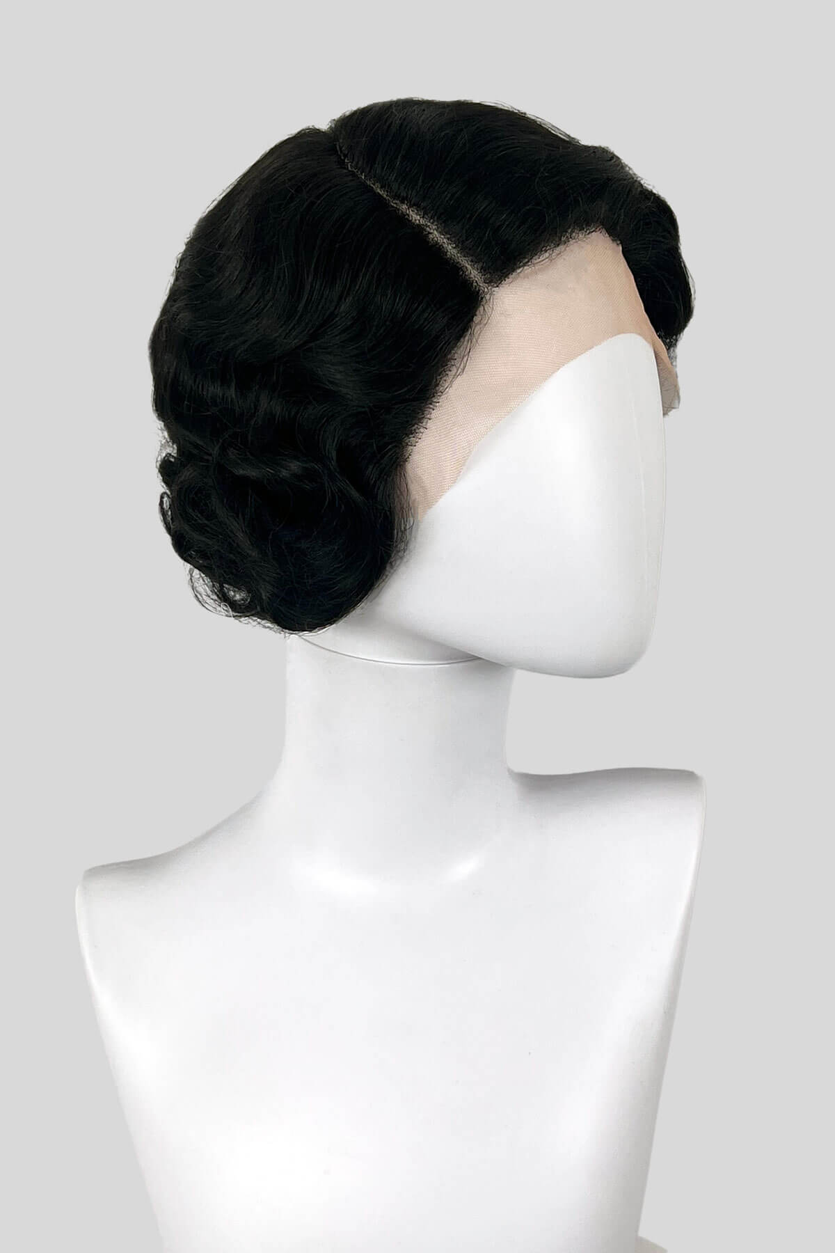 Black wig on a mannequin head against a white background. Black lacefront wig, pinup/vintage style, short with finger waves: Viola