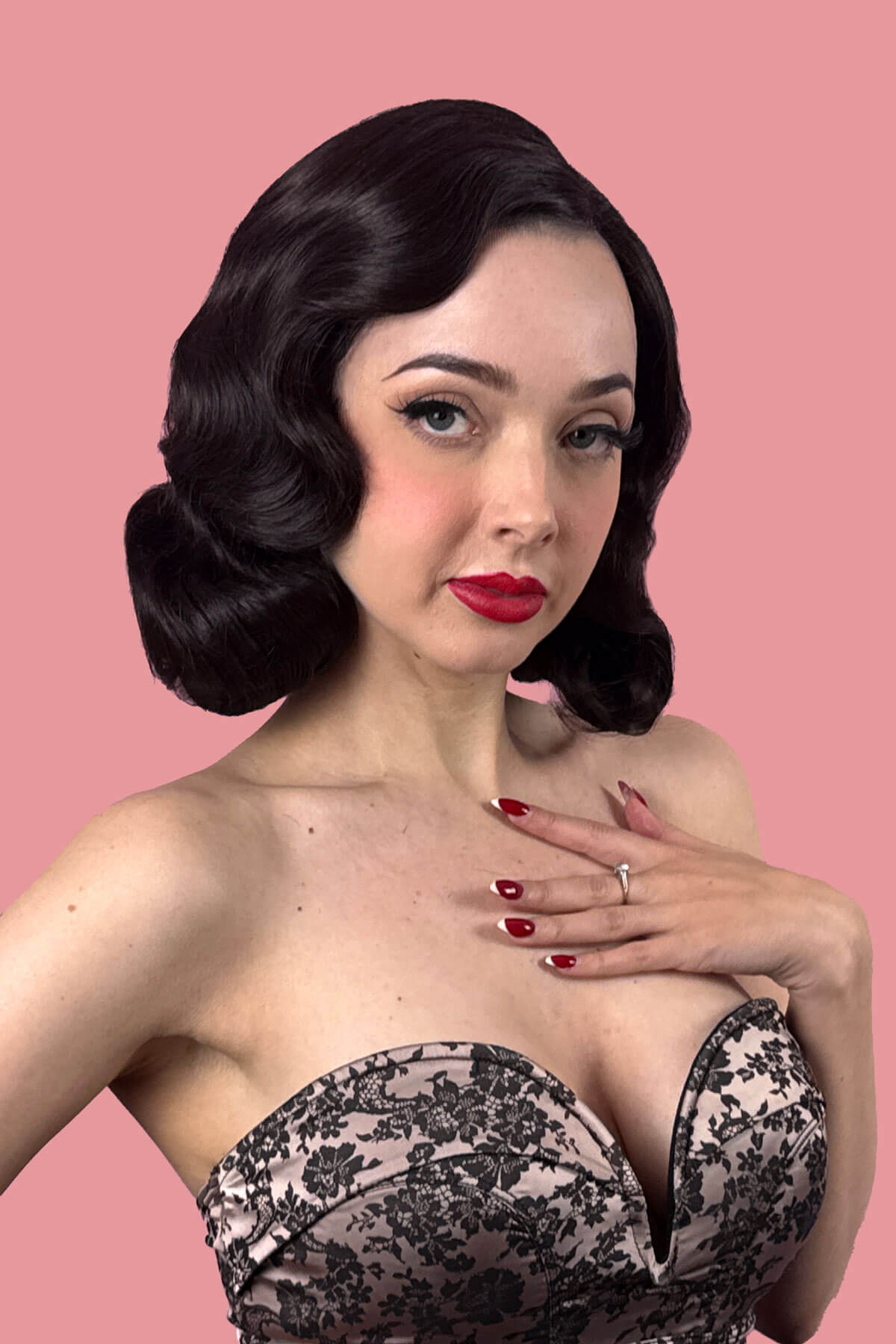 Woman with dark brown vintage style waves in her dark brown hair. Brown lace front wig, pinup/vintage style, mid length with finger waves: Agatha