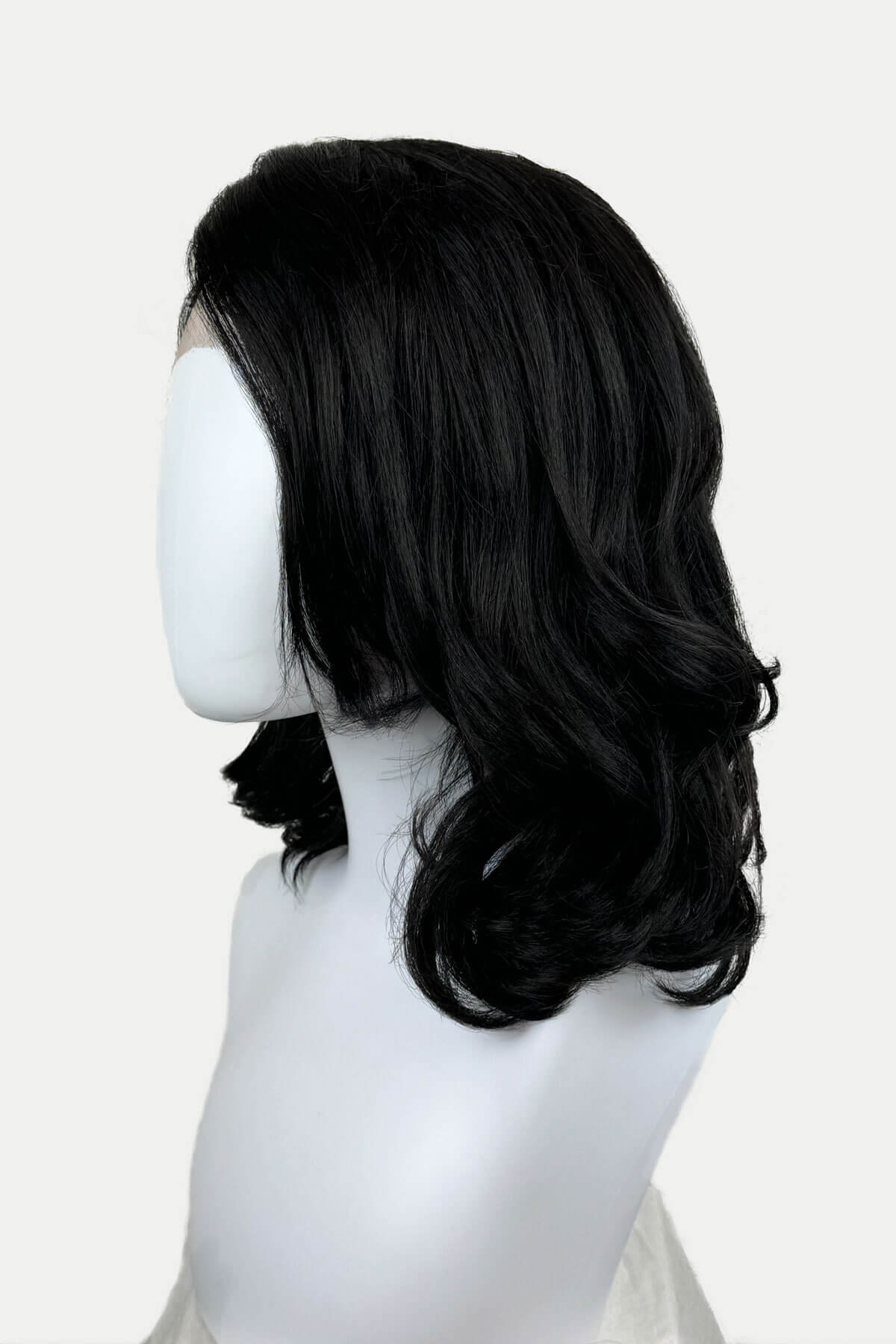 Black lacefront wig with side partingon a mannequin. Black shoulder length long bob (lob) lacefront wig with side sweeping fringe/bangs: Amaris