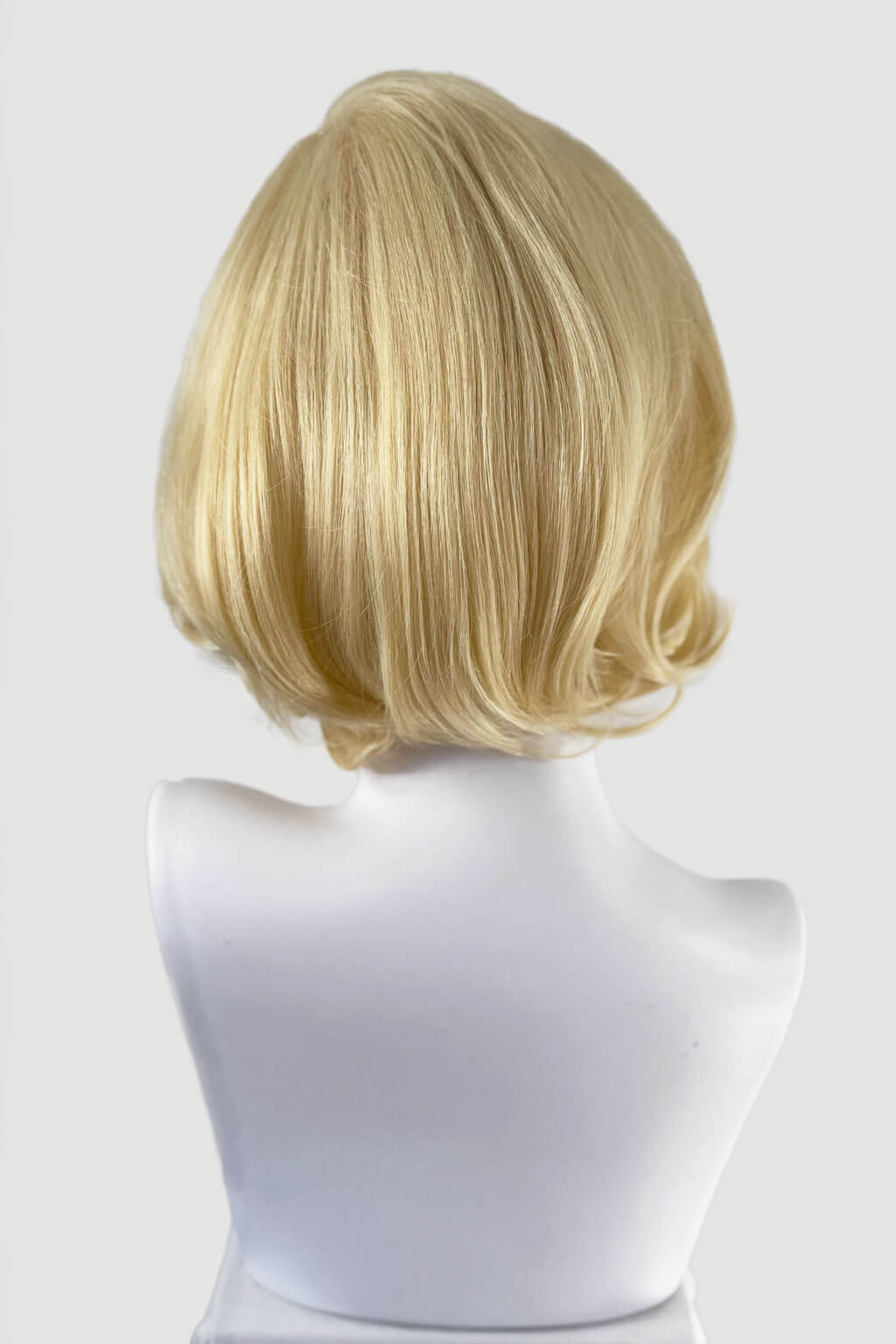 Blonde wig on a white mannequin head against a light gray background. Blonde lacefront wig, pinup/vintage style, mid length, hollywood elegance: Norma Jeane
