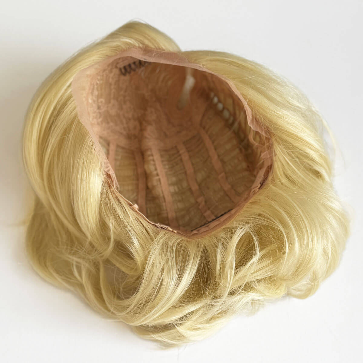 Blonde wig with a brown cap on a white background. Blonde lacefront wig, pinup/vintage style, mid length, hollywood elegance: Norma Jeane