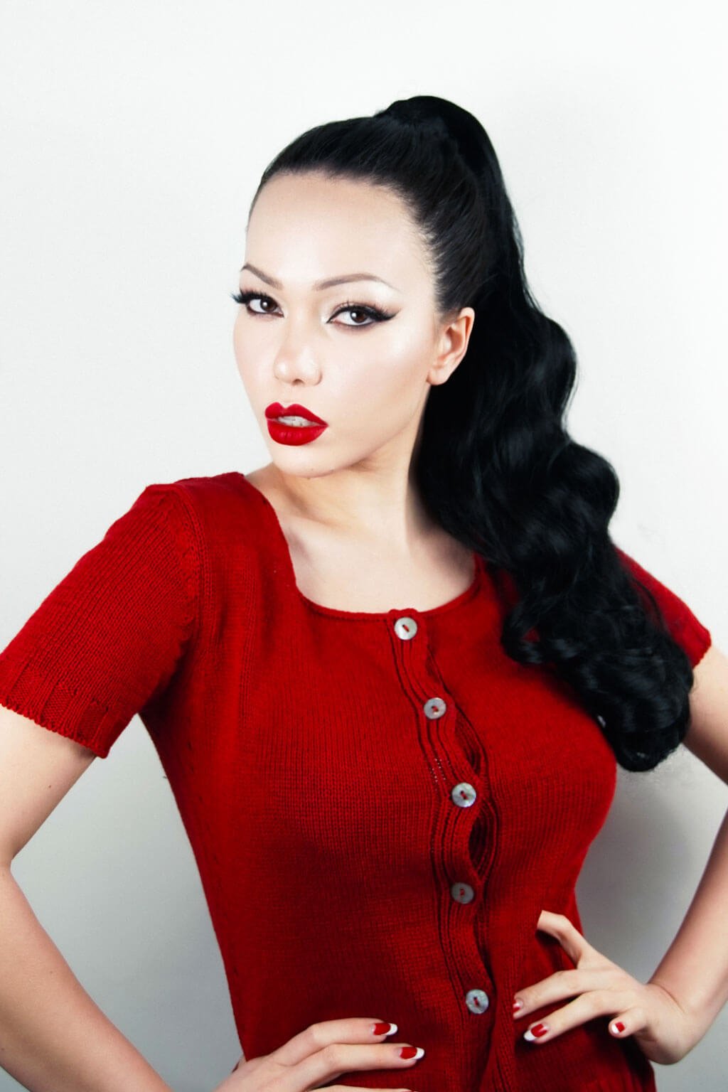 Woman in a red dress with long black hair against a white background - Long ponytail hairpiece with vintage waves: Kitrysha - Jet Black 1