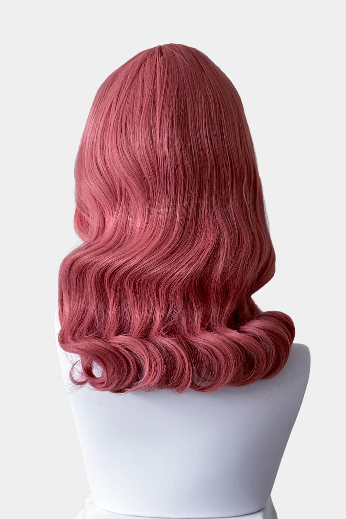 Pink wig on a white mannequin head against a white background. Pink pinup style wig, with finger waves and a short fringe, 1950s style: Stevie