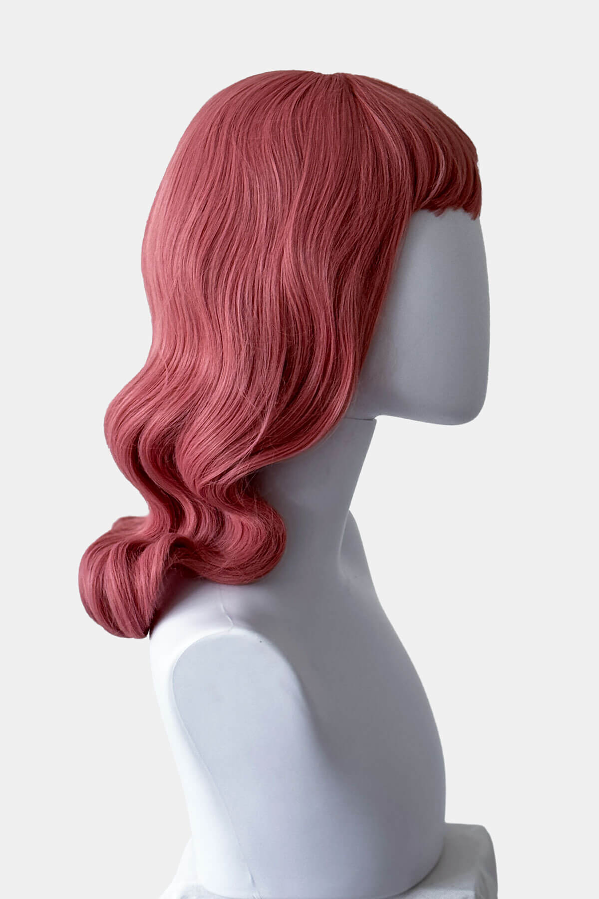 Pink wig on a mannequin head against a white background. Pink pinup style wig, with finger waves and a short fringe, 1950s style: Stevie