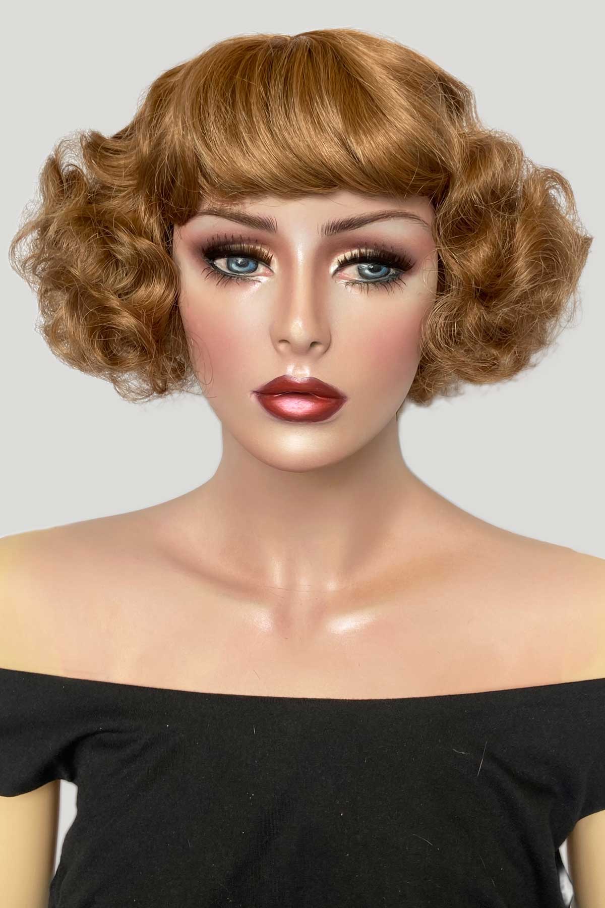 Mannequin head with a styled wig and makeup on a plain background. A short brown vintage style wig with waves: Rita 12-27
