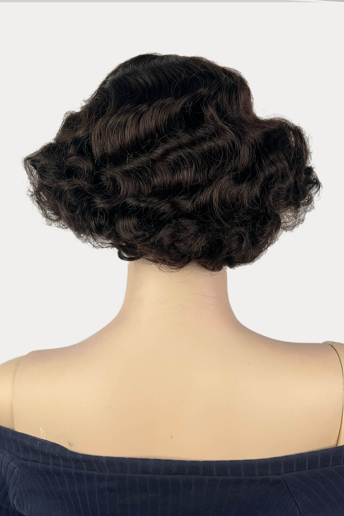 Mannequin head with dark brown wavy hair on a white background. A short brown vintage style wig with waves: Rita dark brown 4