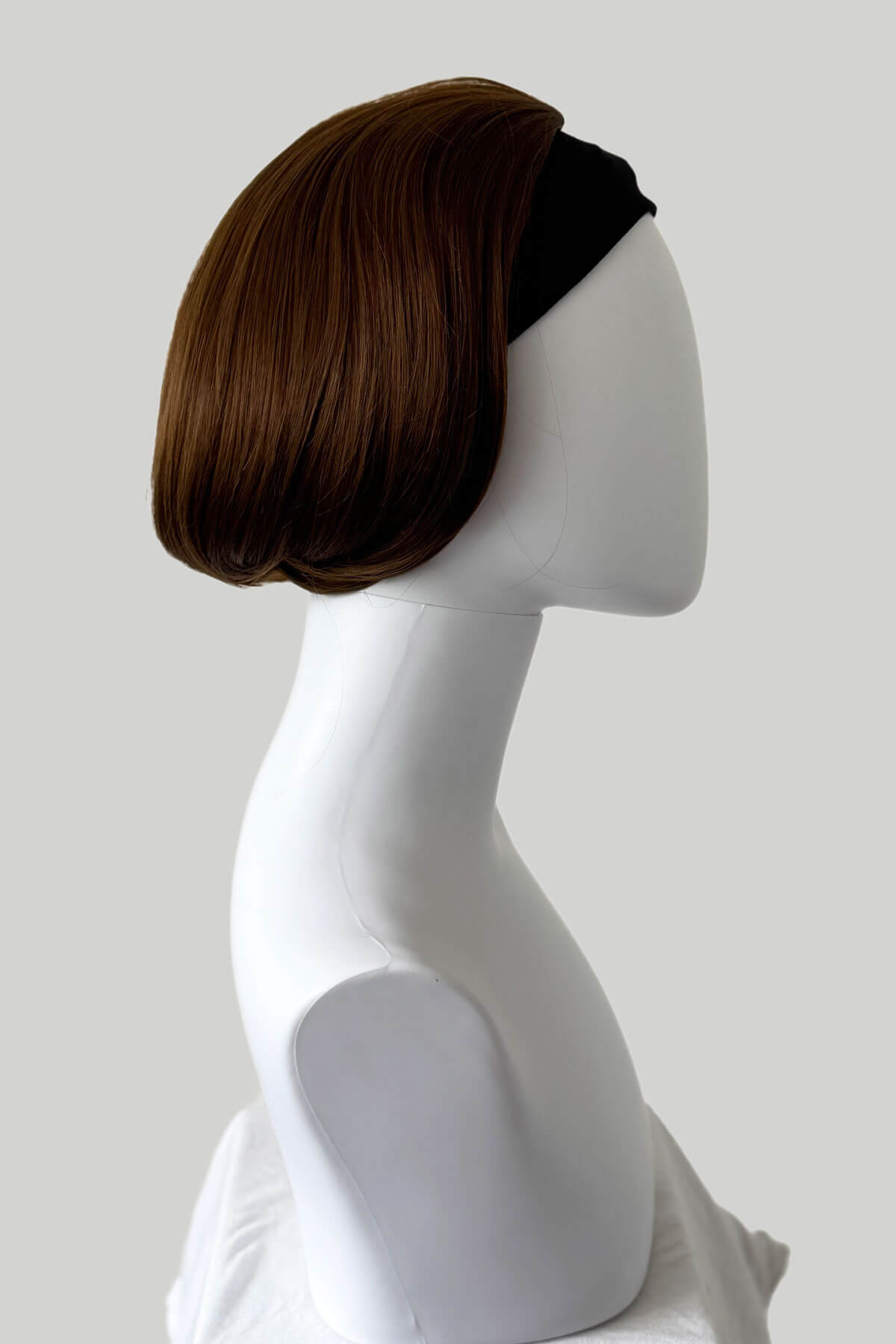 Mannequin head with brown wig and black headband on a white background. Bob half wig hairpiece, heat styleable: Amelie light chocolate brown 12