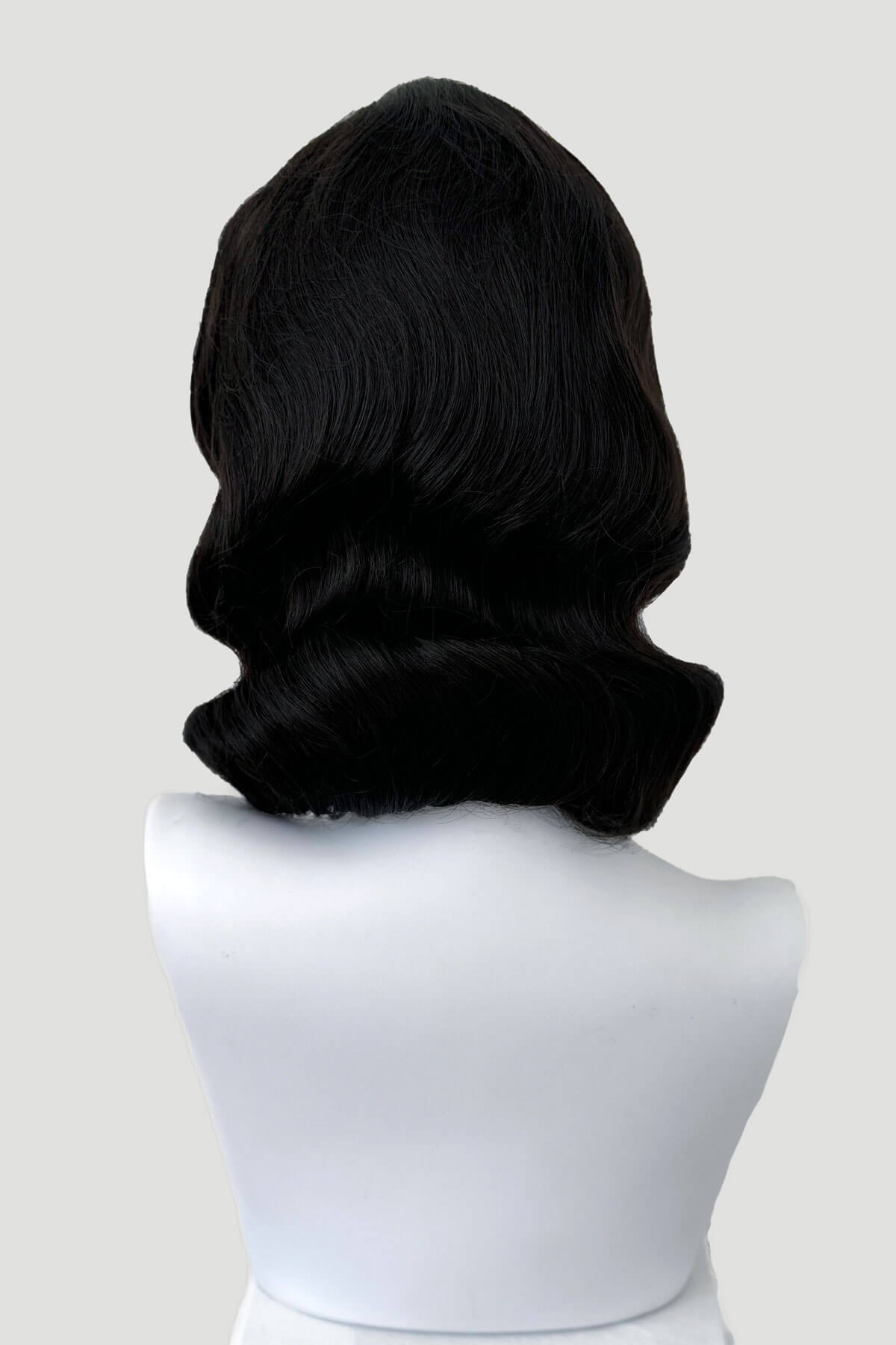 Black wig on a white mannequin head against a light gray background.  Brown 1940s pinup style wig, with finger waves: Honey dark brown 4