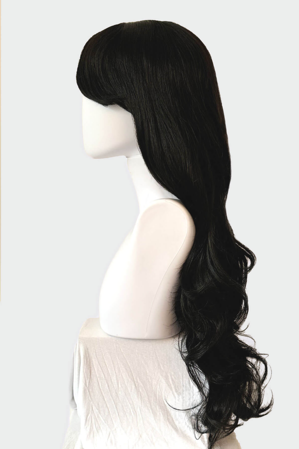Black wig on a mannequin head against a white background. Long black wig, wavy: Kerry