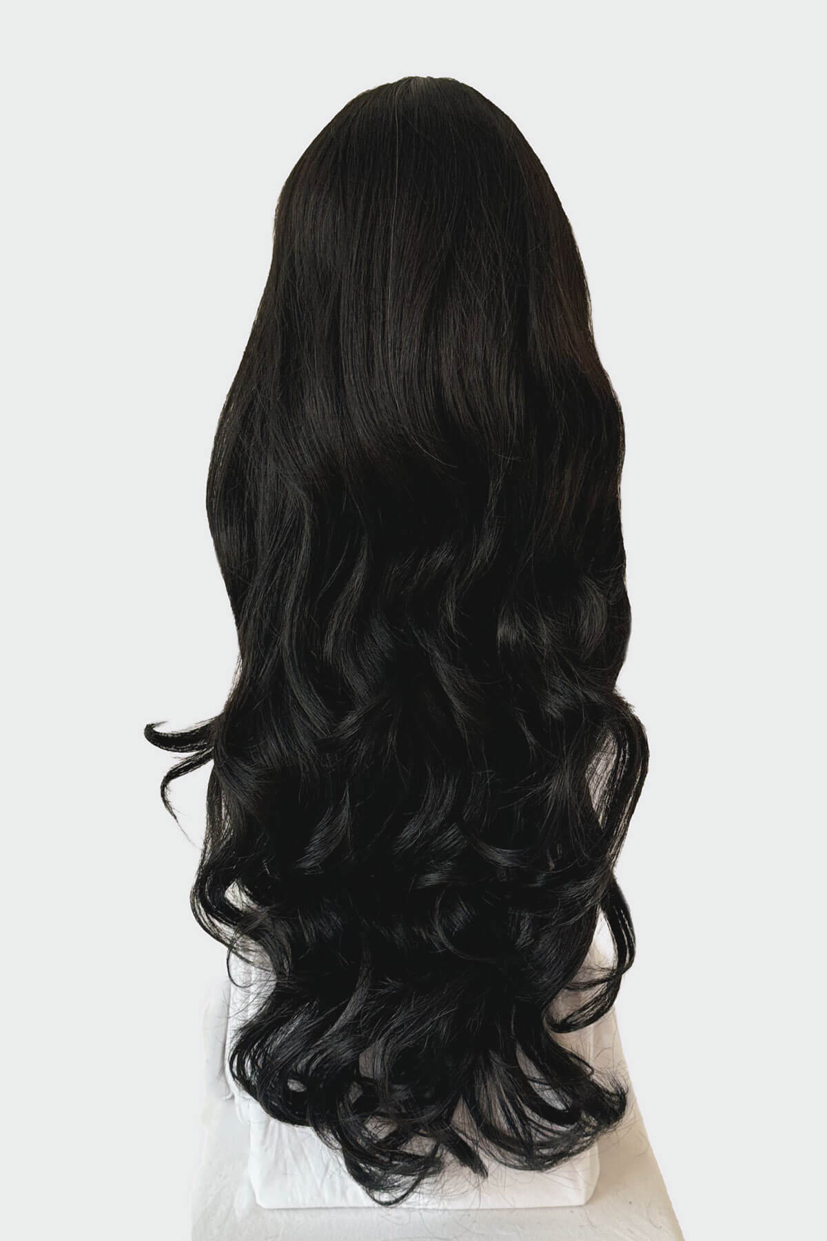 Black wig with wavy hair on a white background. Long black wig, wavy: Kerry