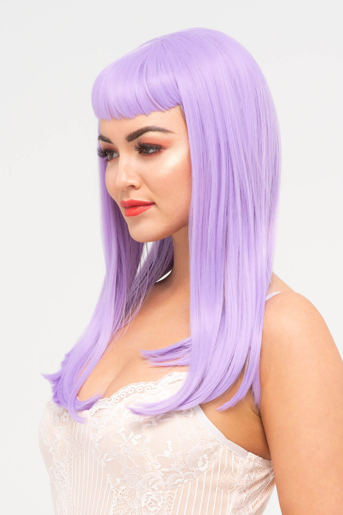Woman wearing a light purple wig with bangs on a white background. Long, Pink-Purple Wig With Short, Straight Fringe: Seraphina