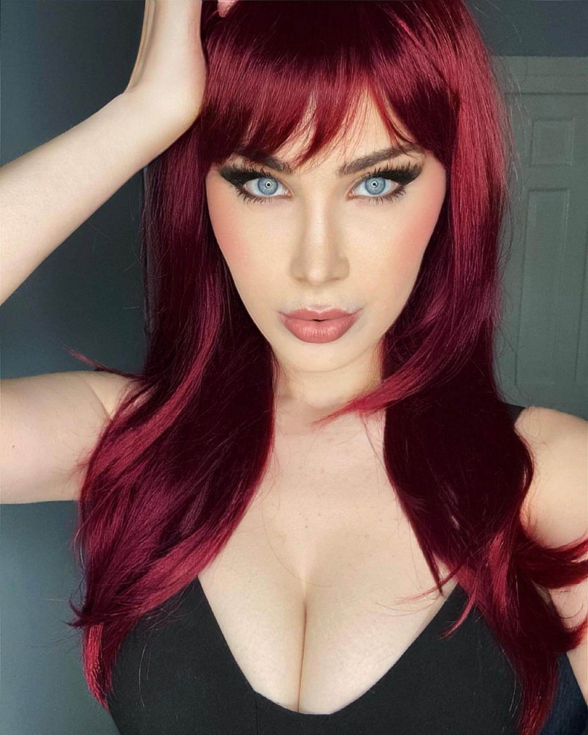 Long red wig in razor cut, face frame style: Megan