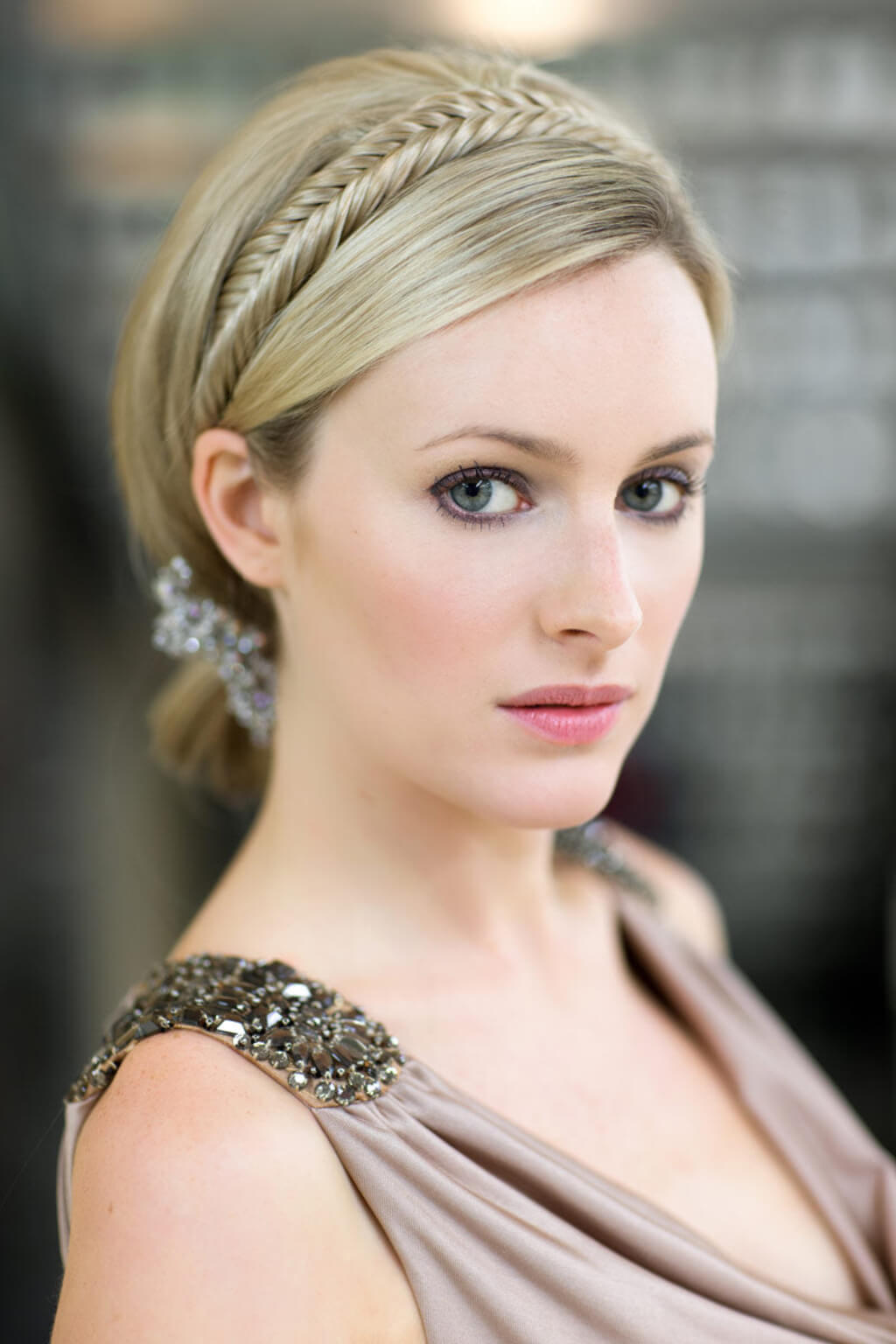 Woman with braided hair wearing a decorative headband and elegant dress.  Fishtail plait hairband (braid) blonde 24H613