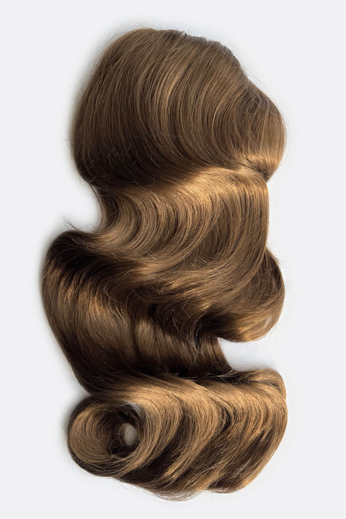 Brown hair extension on a light grey background. Double volume hairpiece extension: Naomi mocha brown 10