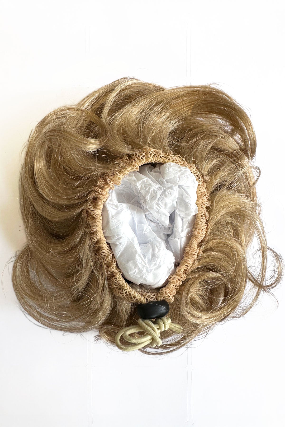 Blonde hair bun accessory on a white background. Curly bun hairpiece, rockabilly style: Toni blonde 613T24